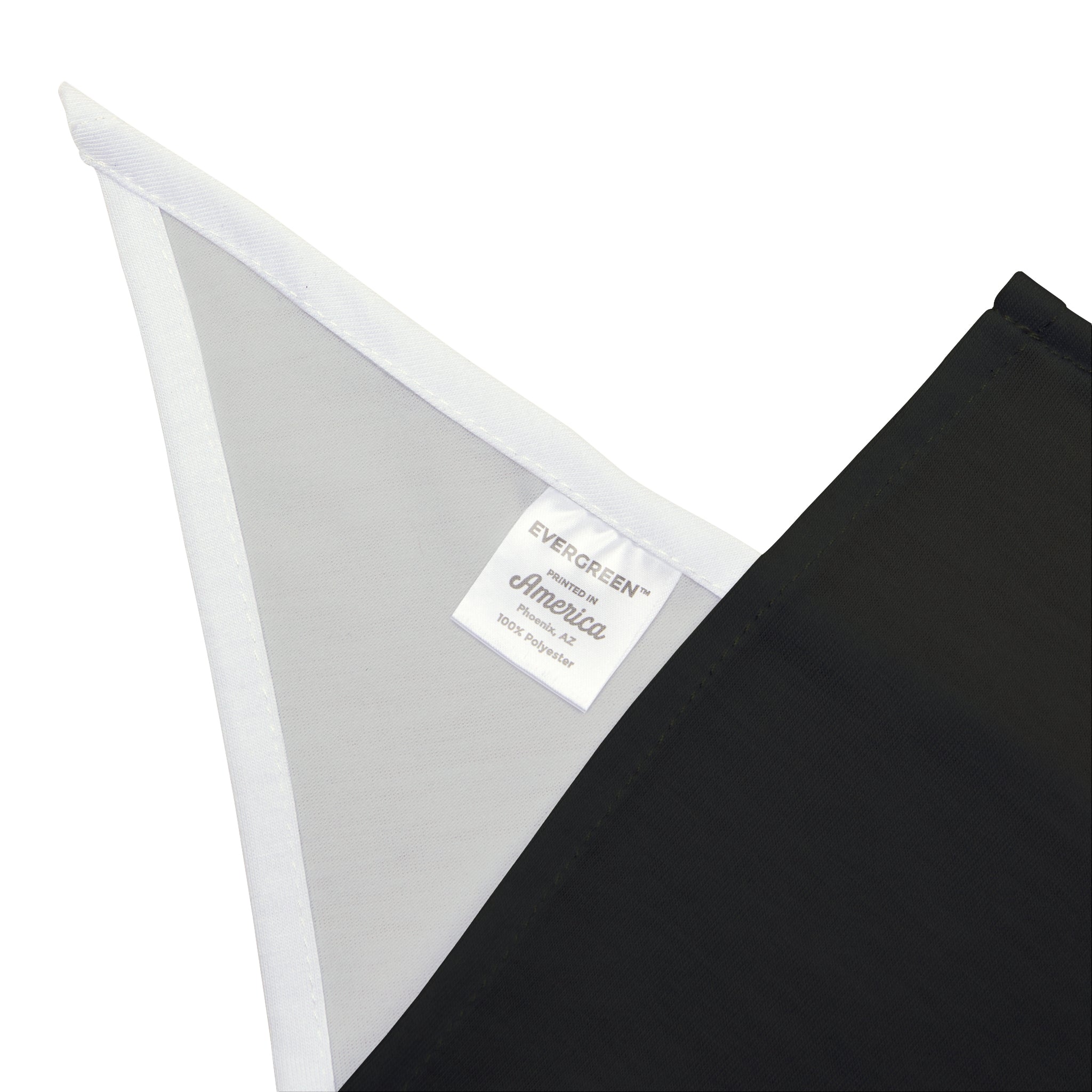 Close-up of an elegantly designed black fabric piece, highlighting a white corner with a label that reads "EVERGREEN America 100% soft-spun polyester," perfect for crafting the "RMRF Problems" pet bandana.