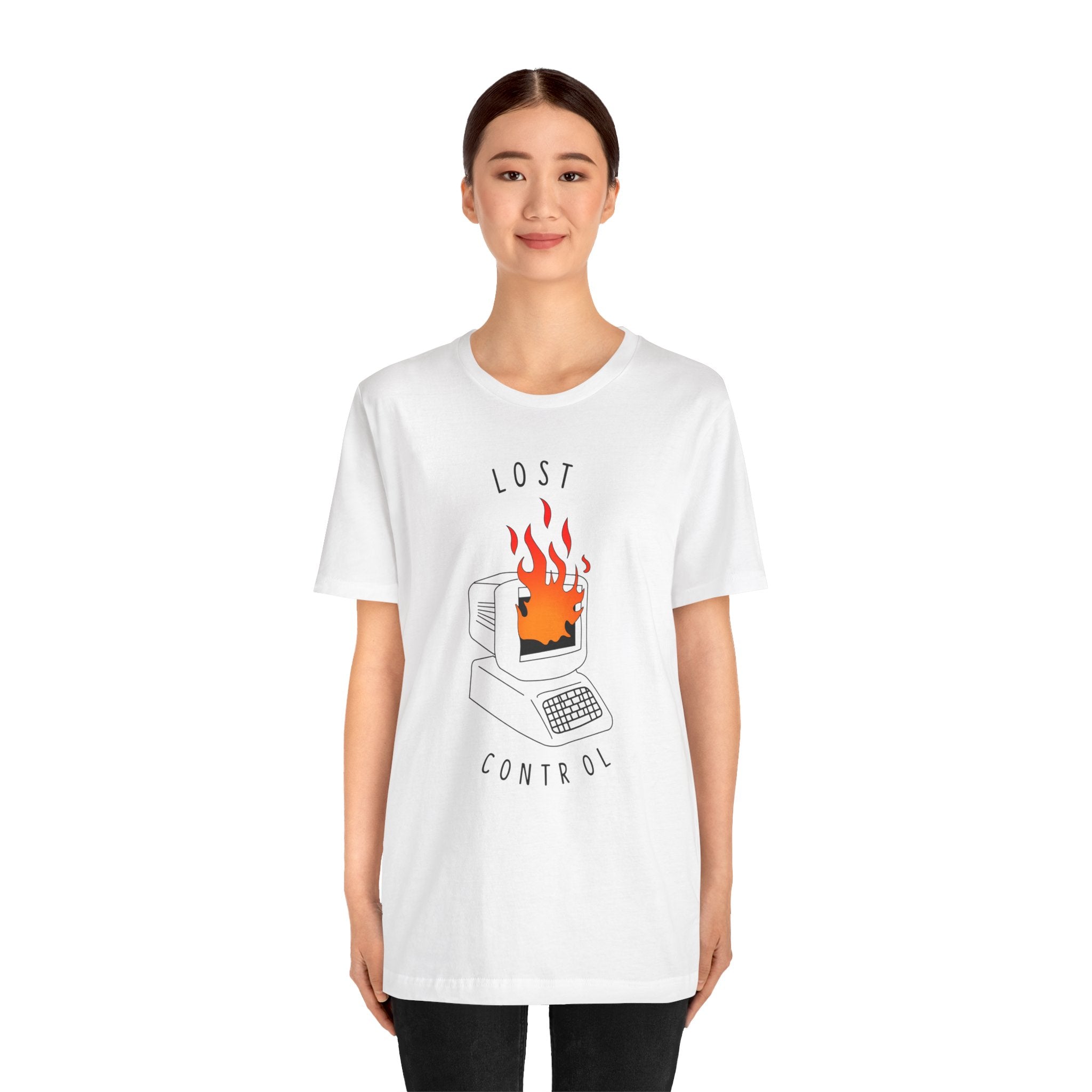 A person sporting the Lost Control T-Shirt, crafted from premium cotton, featuring an illustration of a burning computer alongside the words "LOST CONTROL." This white t-shirt seamlessly combines style and comfort for an ideal wearing experience.