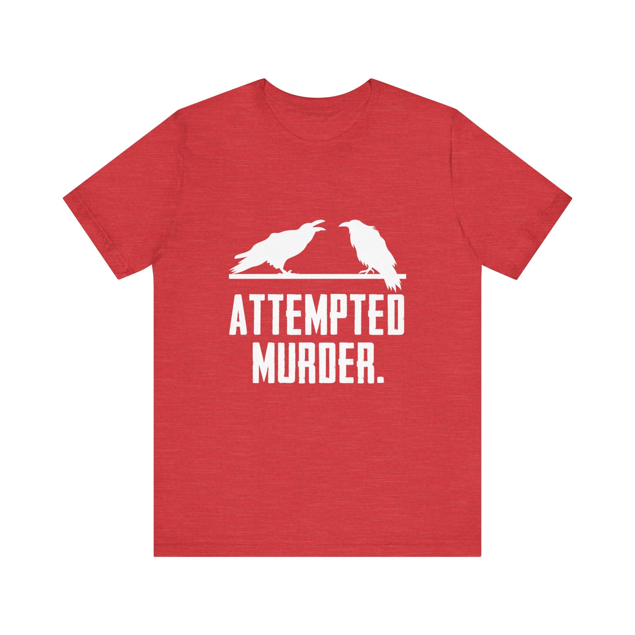 The Attempted Murder T-Shirt showcases a trendy design with a vibrant red color, featuring two crows and the amusing phrase "ATTEMPTED MURDER." It's ideal for anyone wanting to add a humorous touch to their wardrobe.