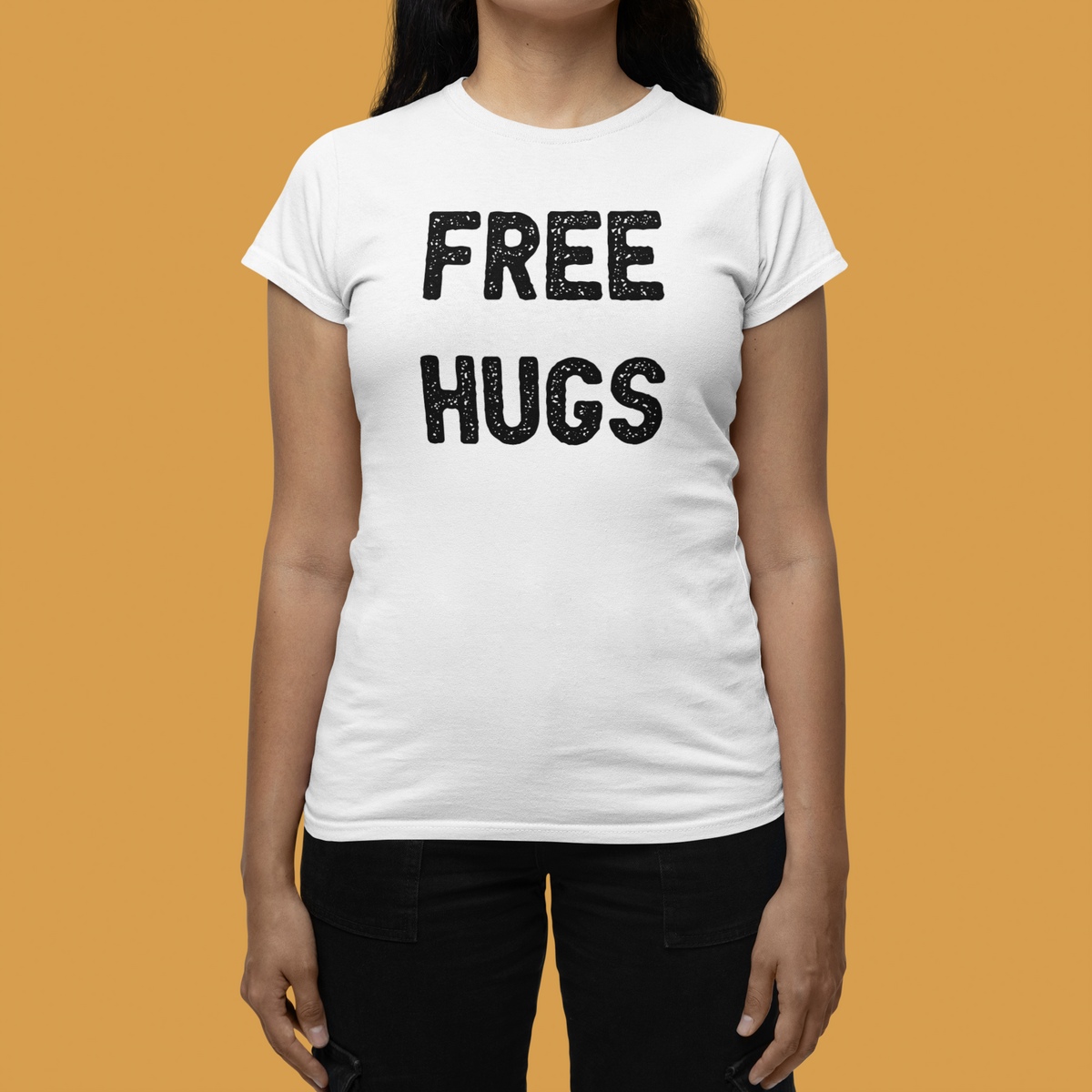 'Free Hugs' women's tee in white, woman wearing it on mustard backdrop, funny sarcastic gift
