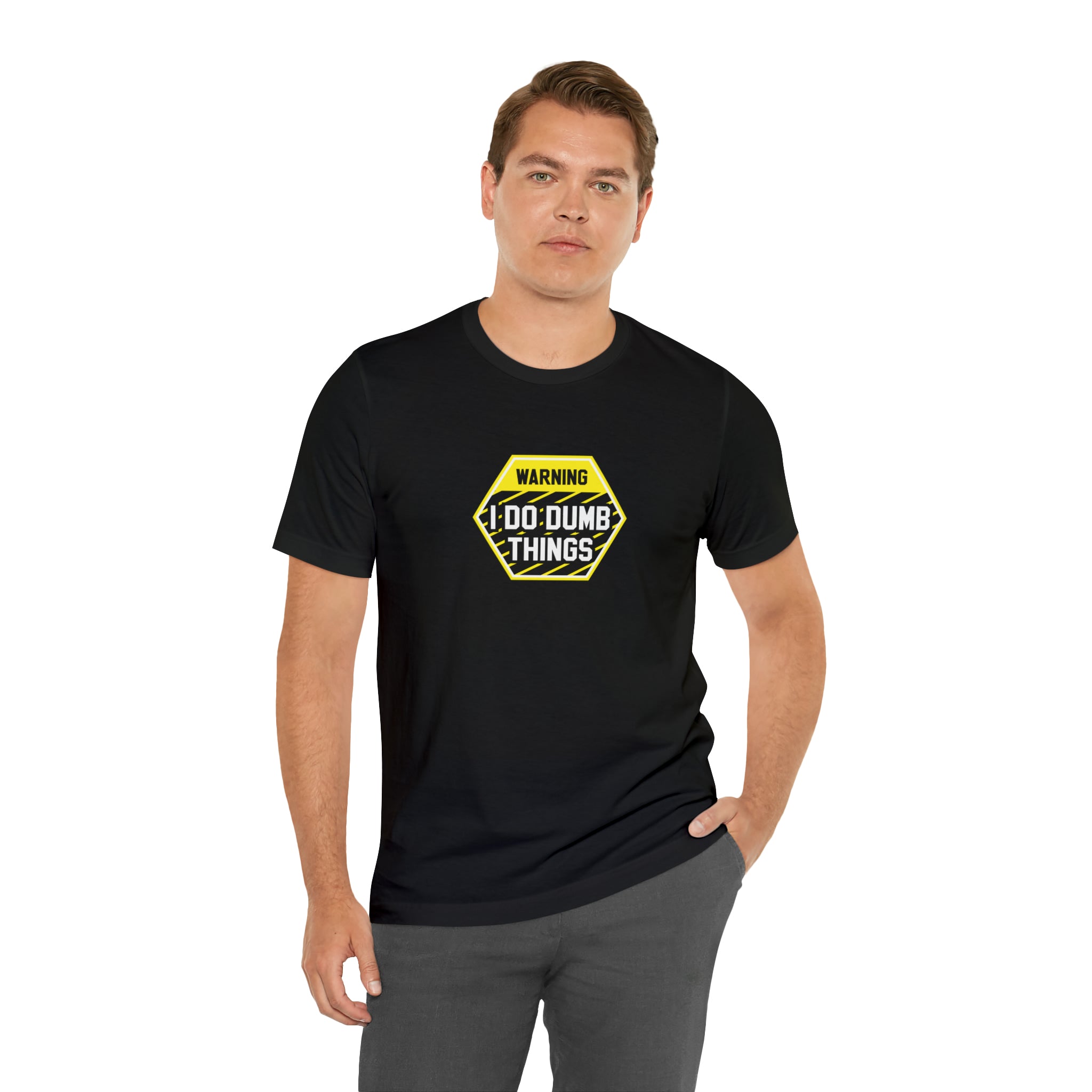 A man wearing a Printify Warning - I do dumb things T-Shirt with a yellow warning sign.