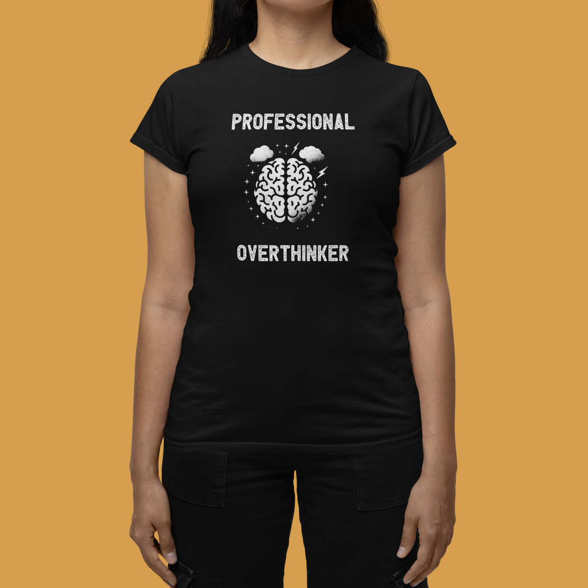 'Professional Overthinker' women's tee in black, woman on mustard background, funny brain graphic tee