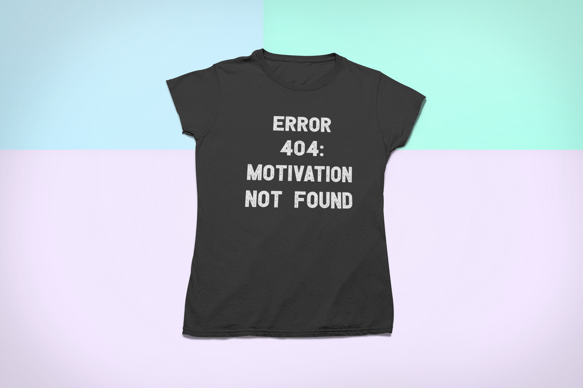 'Error 404 Motivation Not Found' t-shirt in black, flat lay on pastel background, funny developer tee