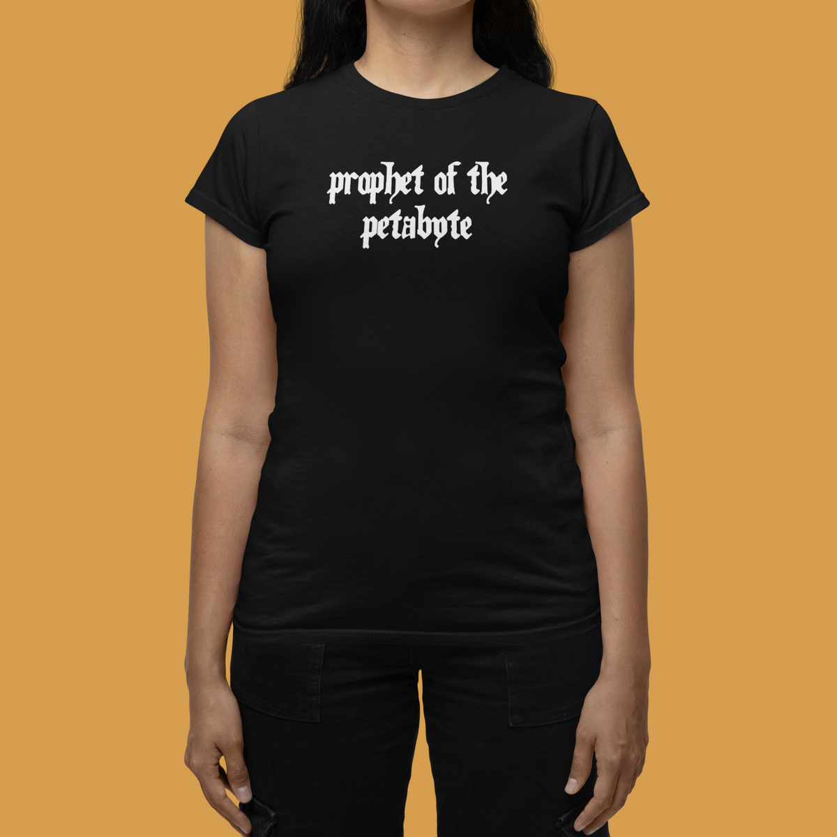 'Prophet of the Petabyte' women's t-shirt in black, woman wearing it on orange background, funny data nerd gift