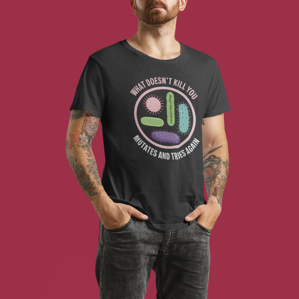 'What Doesn't Kill You' virus graphic t-shirt in black, tattooed man wearing it, funny science gift