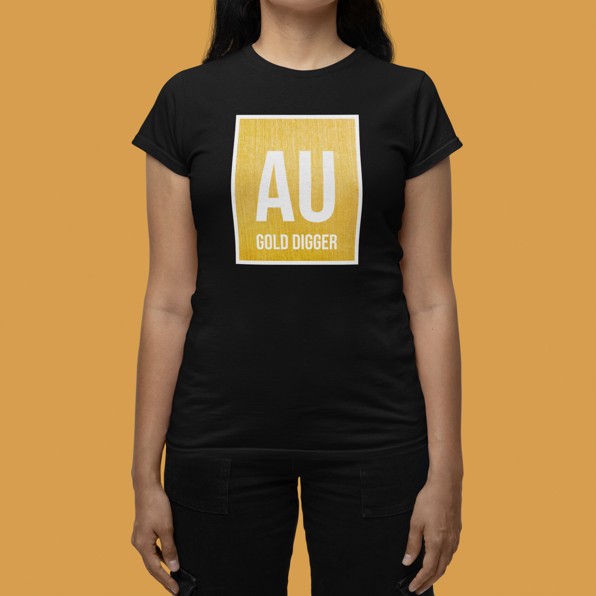 'AU Gold Digger' women's fitted t-shirt in black, woman wearing it against orange backdrop, funny science teacher gift
