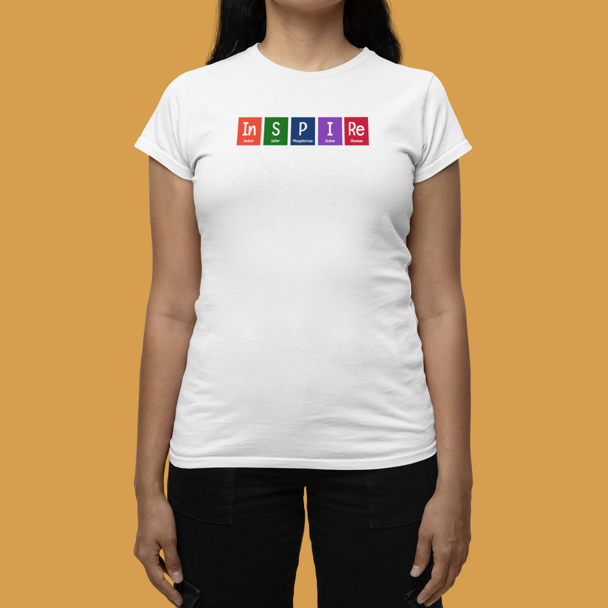 'InSPIRe' periodic table t-shirt in white, woman wearing it, mustard backdrop, chemistry pun gift