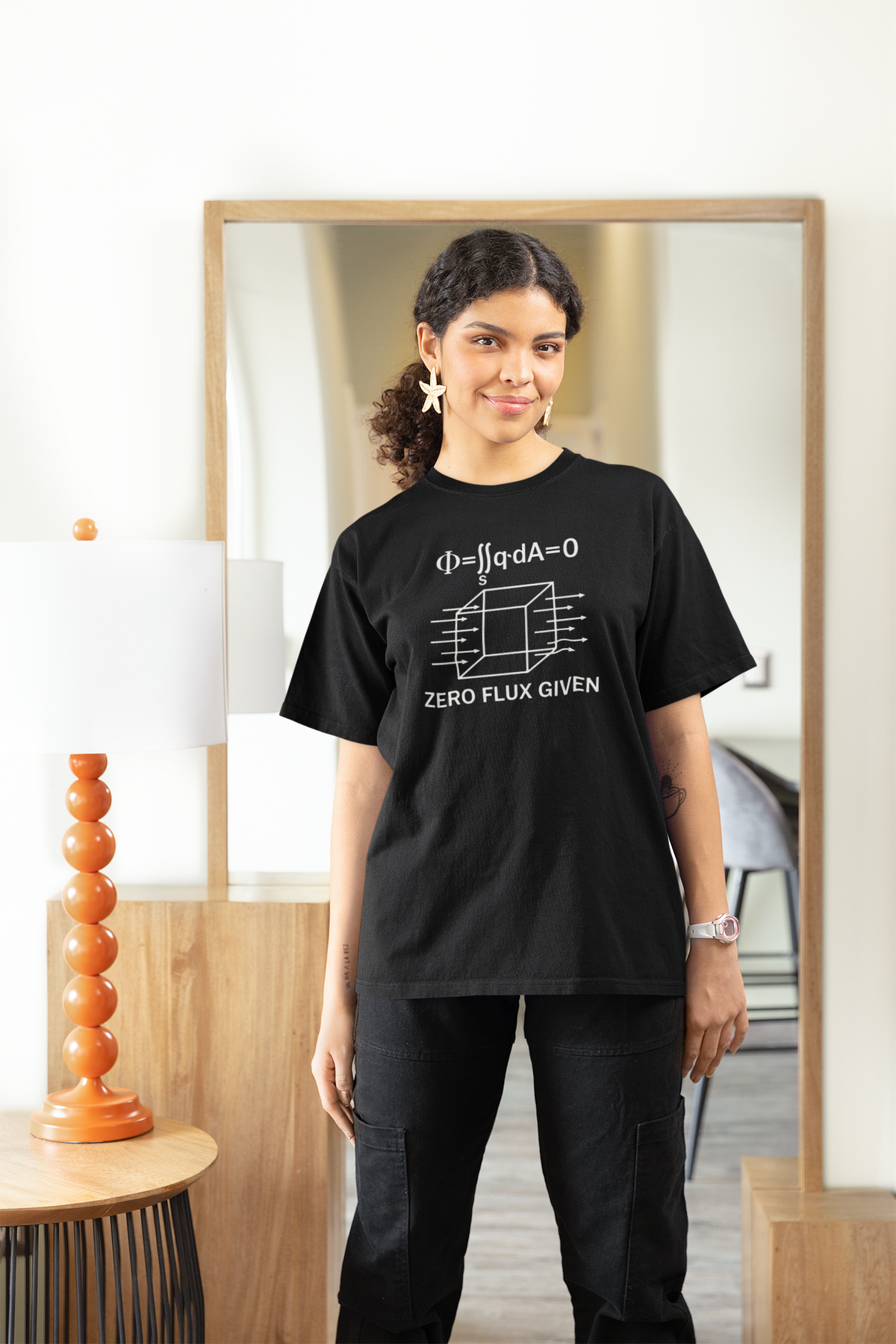 'Zero Flux Given' physics equation Women's Tee in black, woman wearing it at home, funny science pun tee