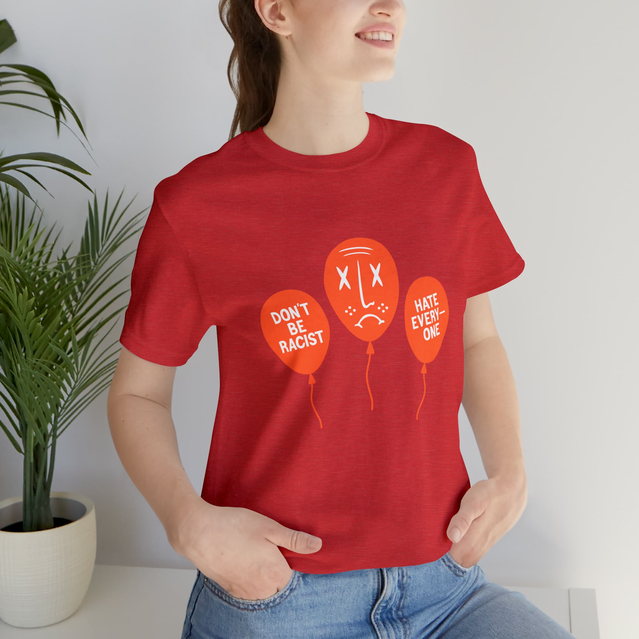 A suave woman rocking a bold red Don't Be T-Shirt adorned with vibrant balloons.