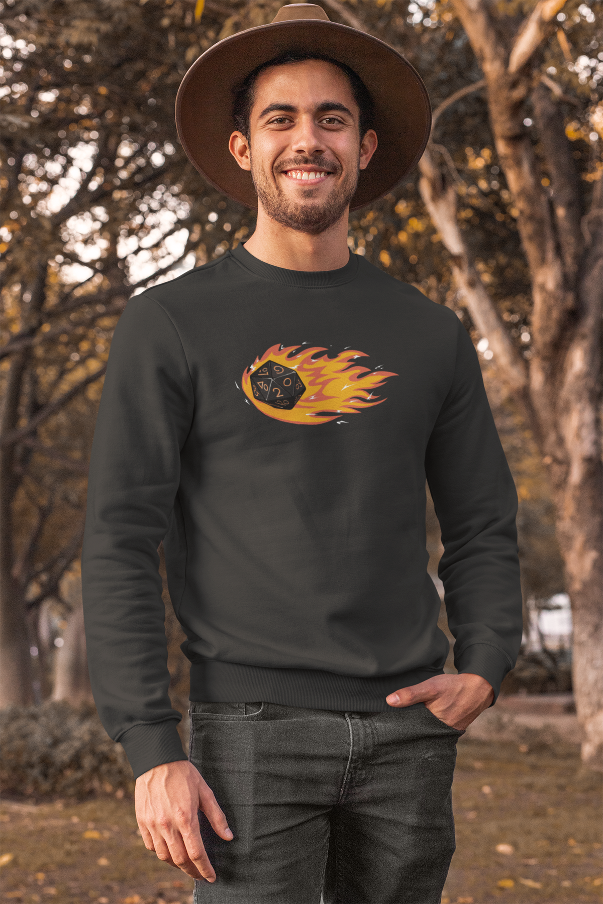 "Polyhedral Dice On Fire" sweatshirt in charcoal, man wearing a hat outdoors, funny tabletop gamer gift
