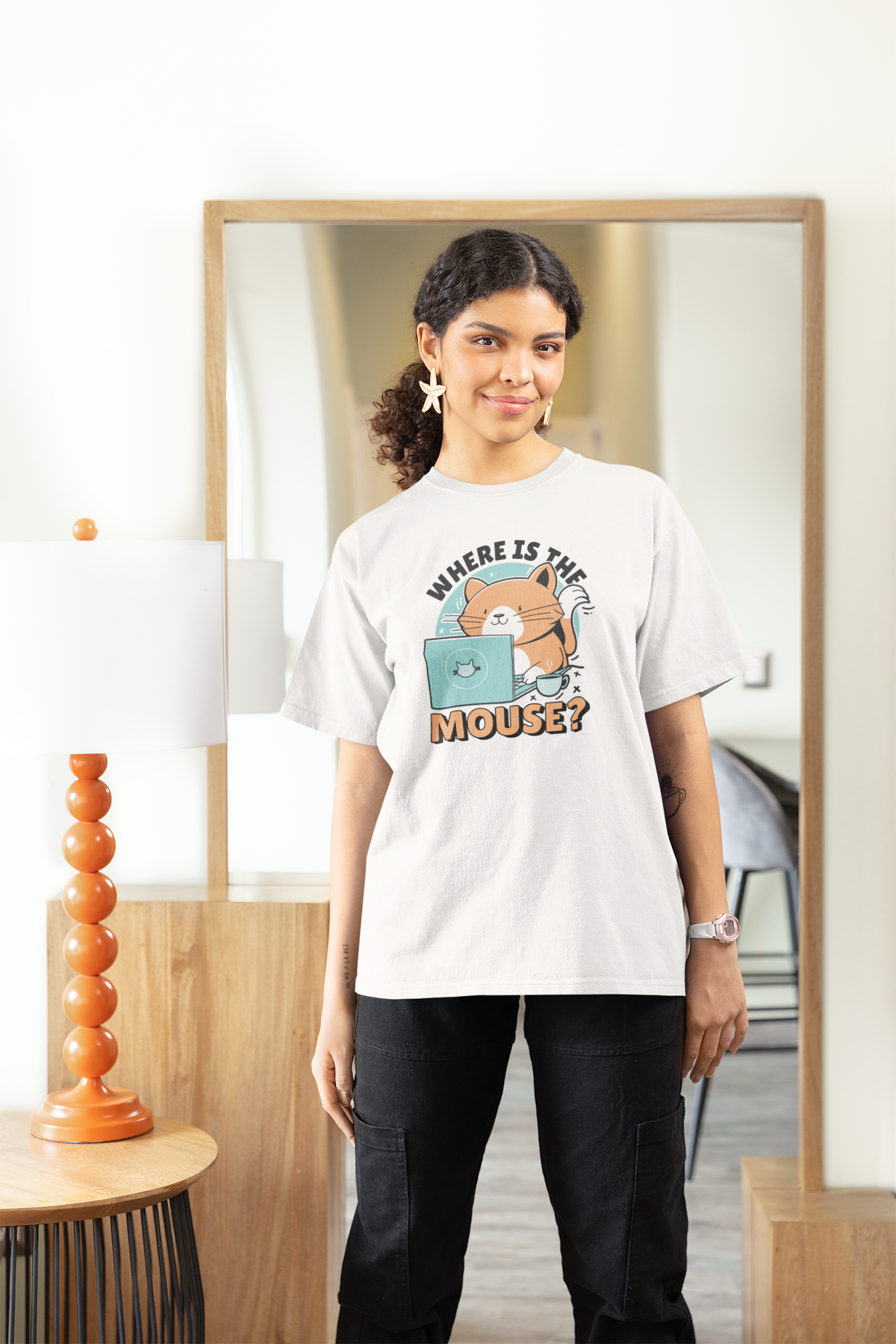 "Where Is The Mouse?" cat graphic tee in white, woman wearing it at home, funny gift for cat owners