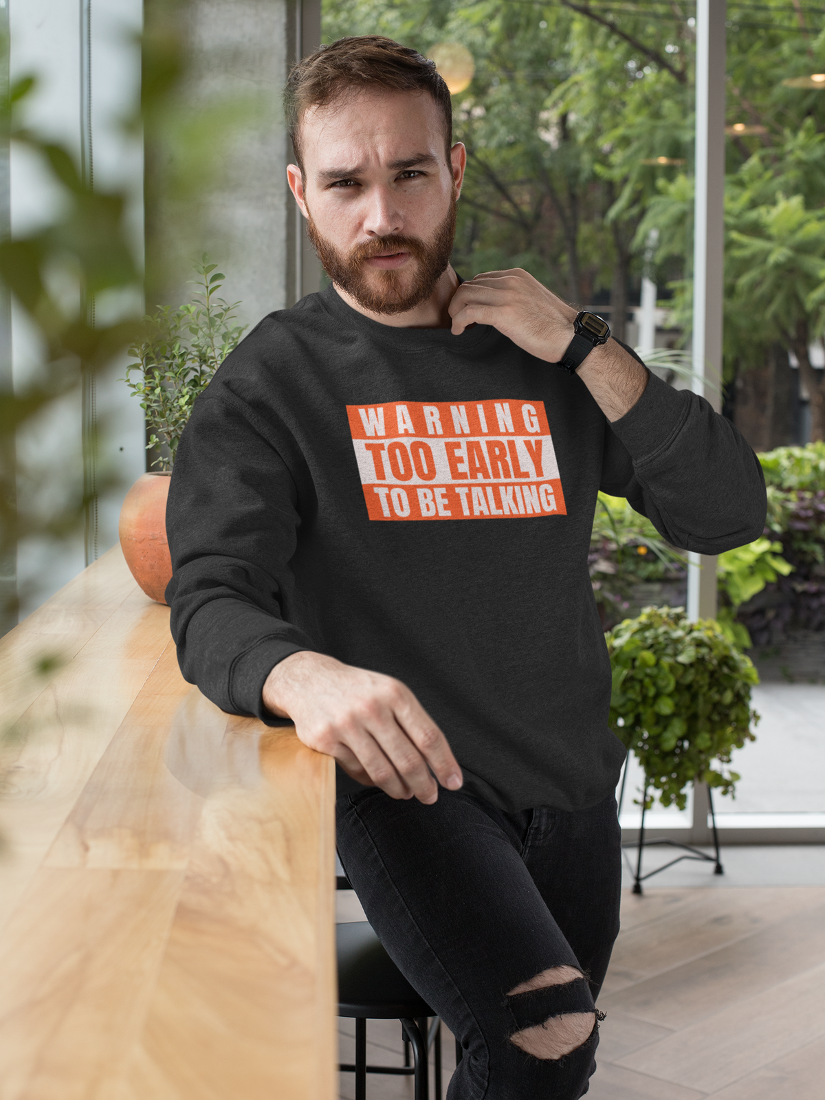 'Warning Too Early To Be Talking' sweatshirt in black, bearded man sitting outdoors, funny sarcastic gift