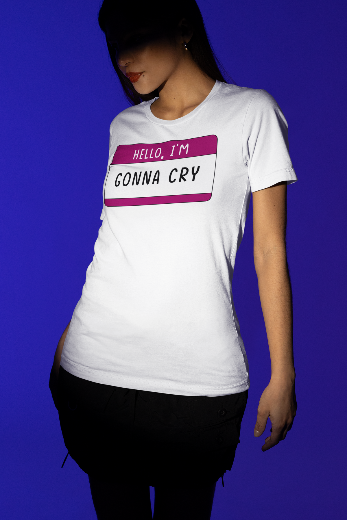 Hello I'm Gonna Cry name tag T-shirt in white, woman wearing it against a blue backdrop, funny tee