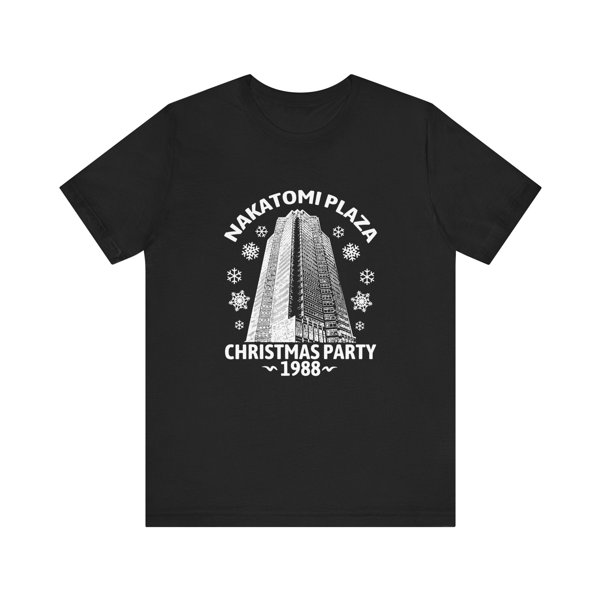 Nakatomi Plaza Christmas Party 1988 T-Shirt featuring a monochrome graphic of Nakatomi Plaza with snowflakes and text that reads "Nakatomi Plaza Christmas Party 1988", crafted from breathable cotton.