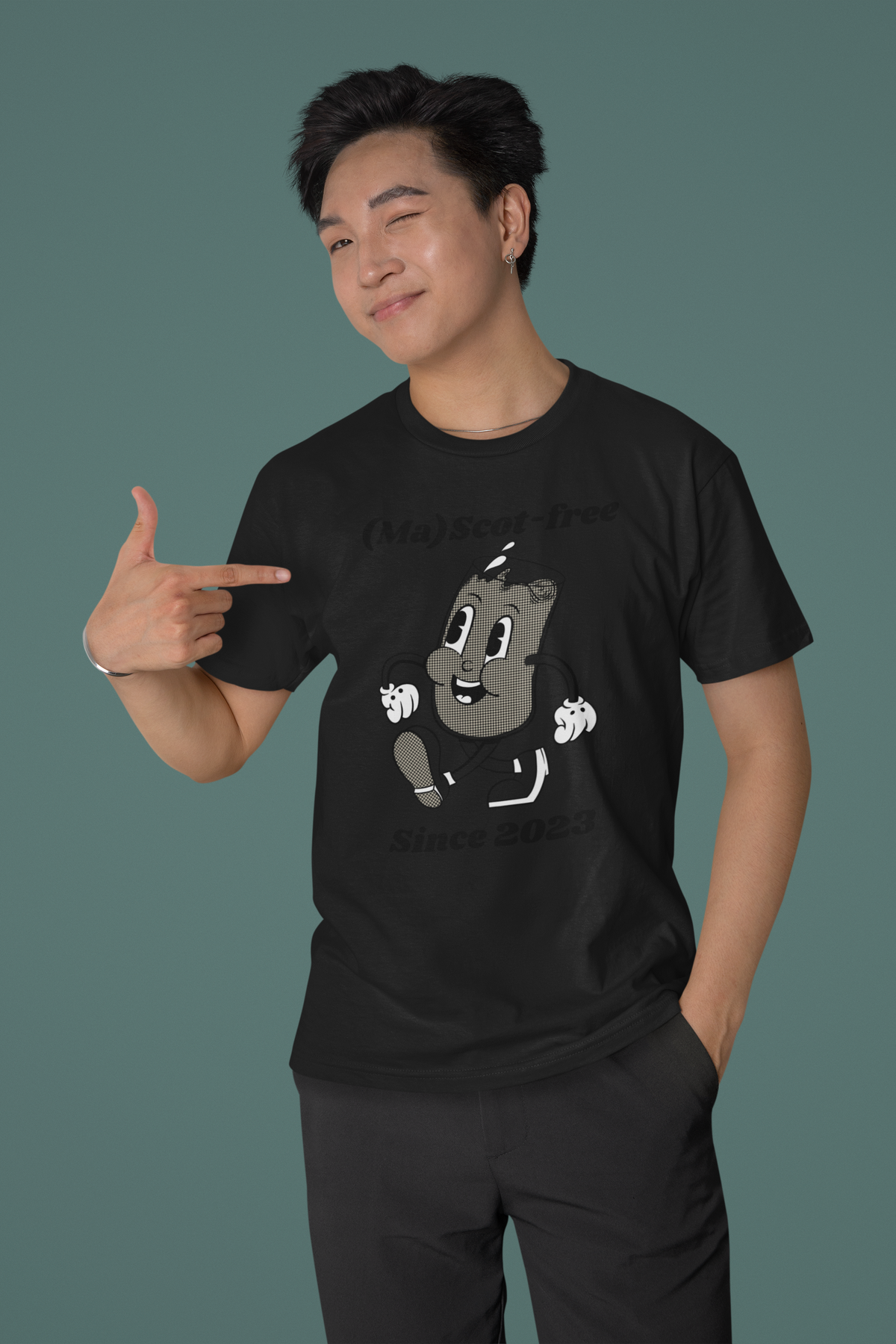 'Ma(scot)-free' milk carton t-shirt in black, man pointing at it, funny pun gift shirt