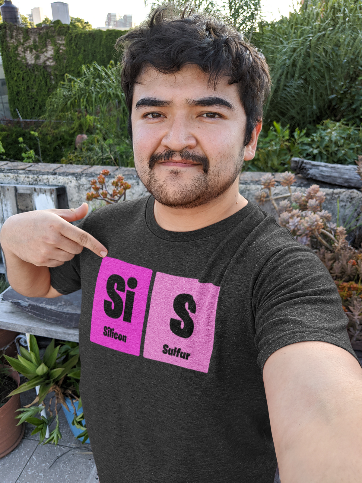 'Sis' periodic table t-shirt in heather grey, man pointing at the print, funny sisters pun tee