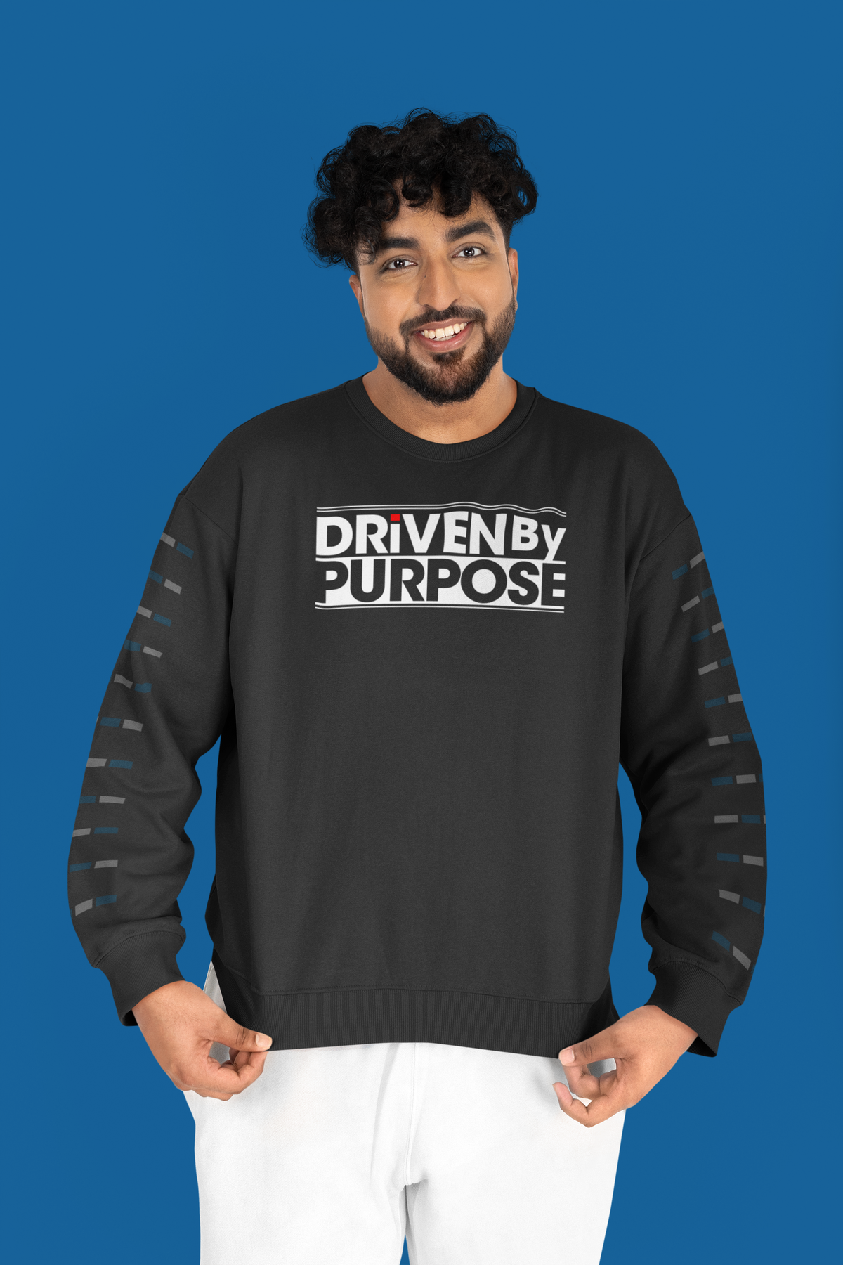Driven by Purpose Sweatshirt in black, man wearing it against a blue backdrop, motivational streetwear gift