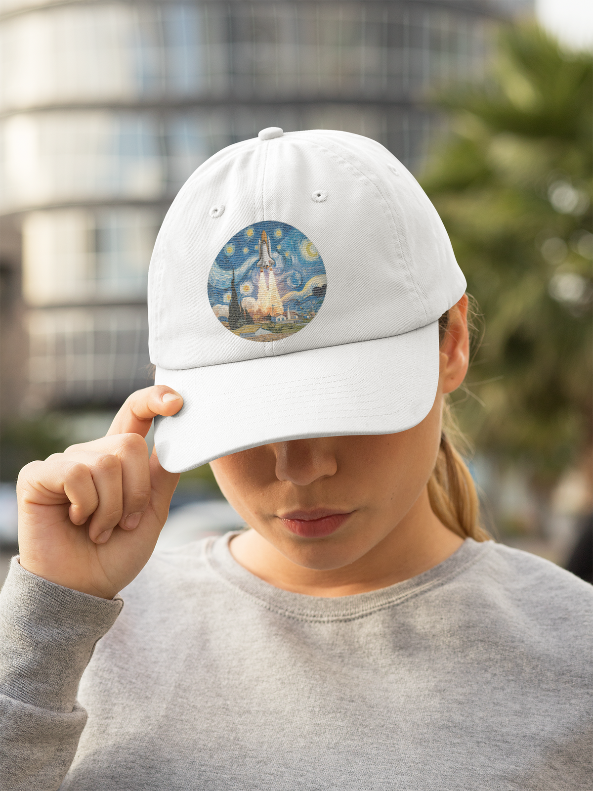 Van Gogh Spaceship Hat in white, woman wearing it outdoors adjusting brim, casual space art dad hat