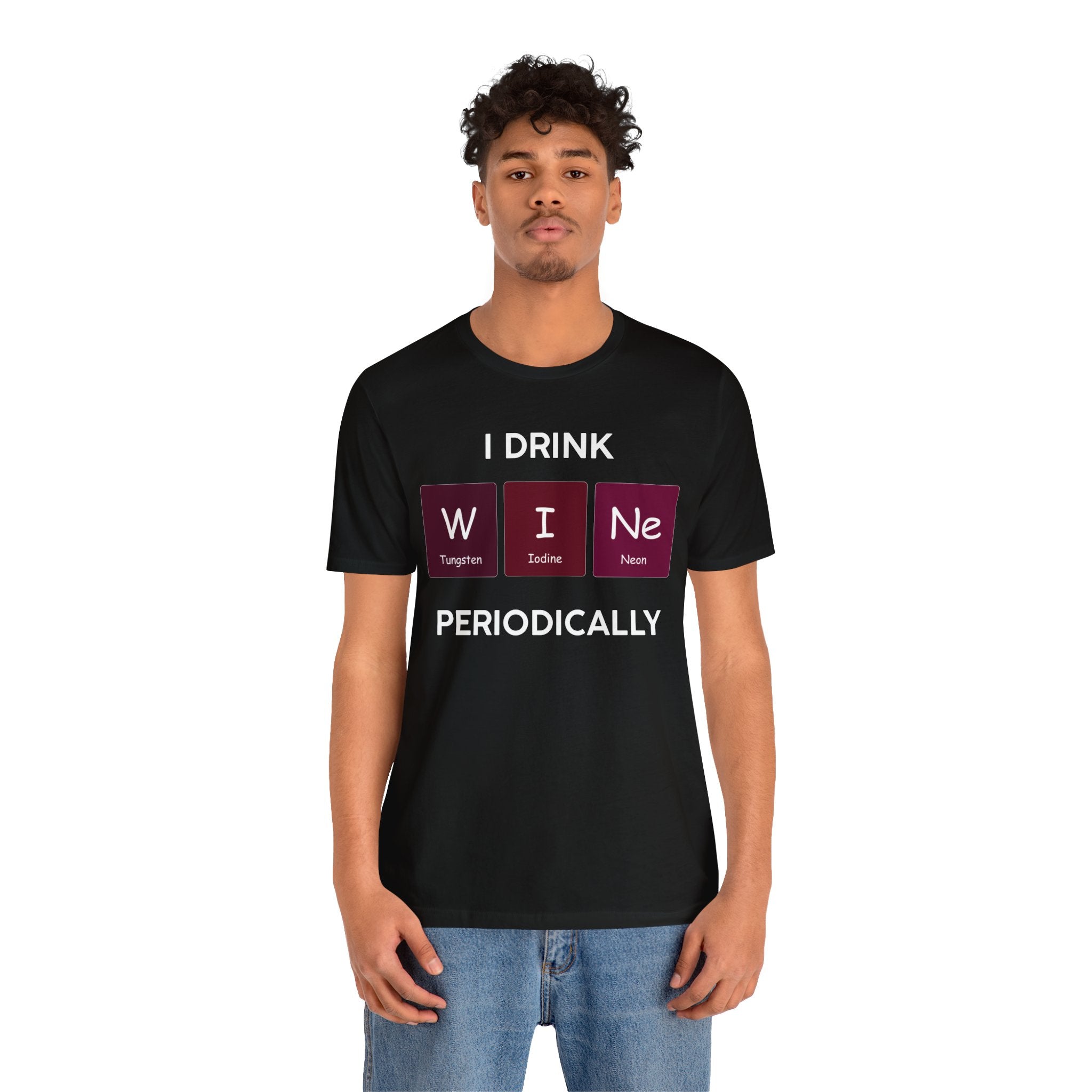 Young man wearing a black unisex jersey tee with a quality print saying "I Drink W-I-Ne" using elements from the periodic table.