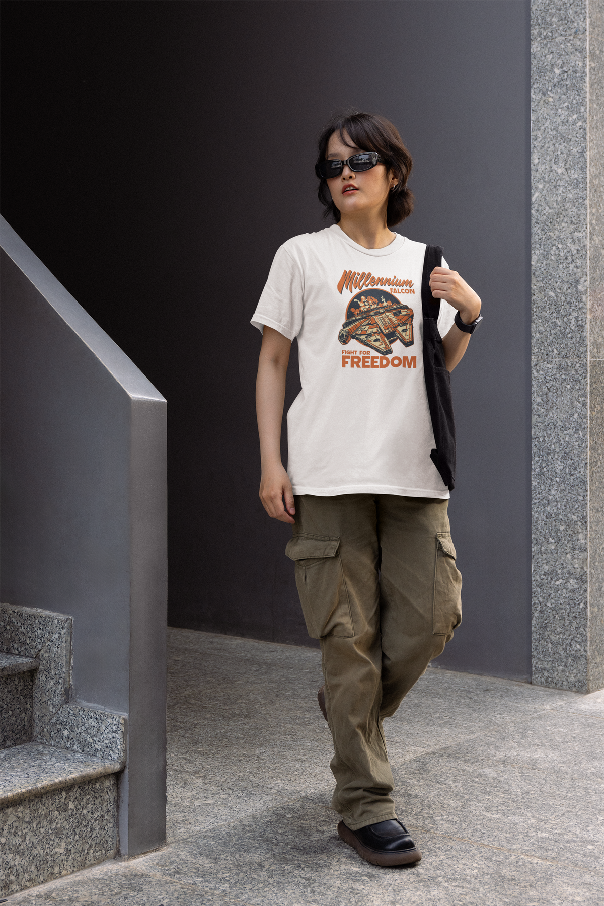 'Millennium Falcon Fight for Freedom' t-shirt in white, woman wearing it walking outdoors, cool sci-fi fan streetwear