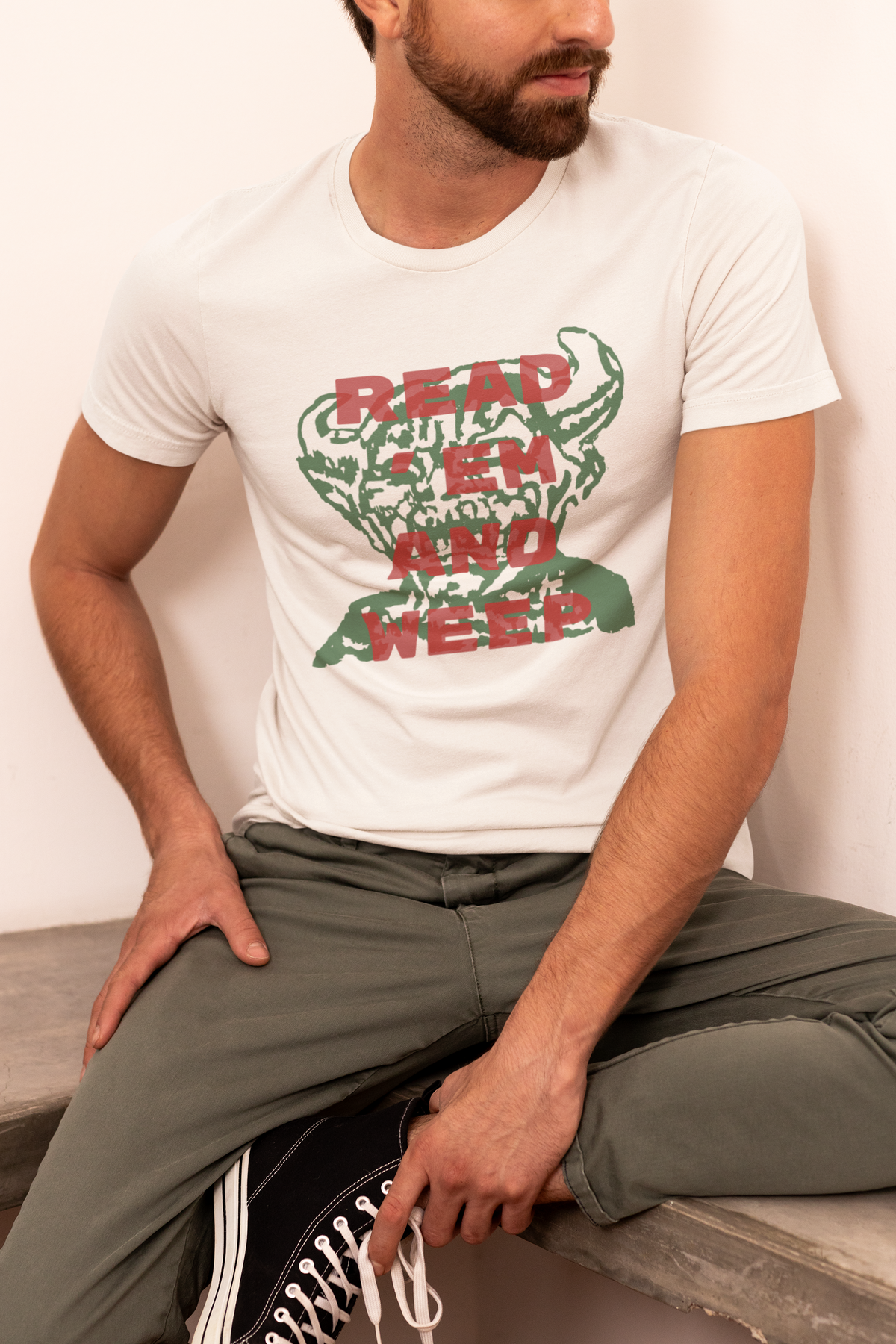 'Read Them And Weep' t-shirt in cream, man sitting wearing it, funny gambler gift shirt