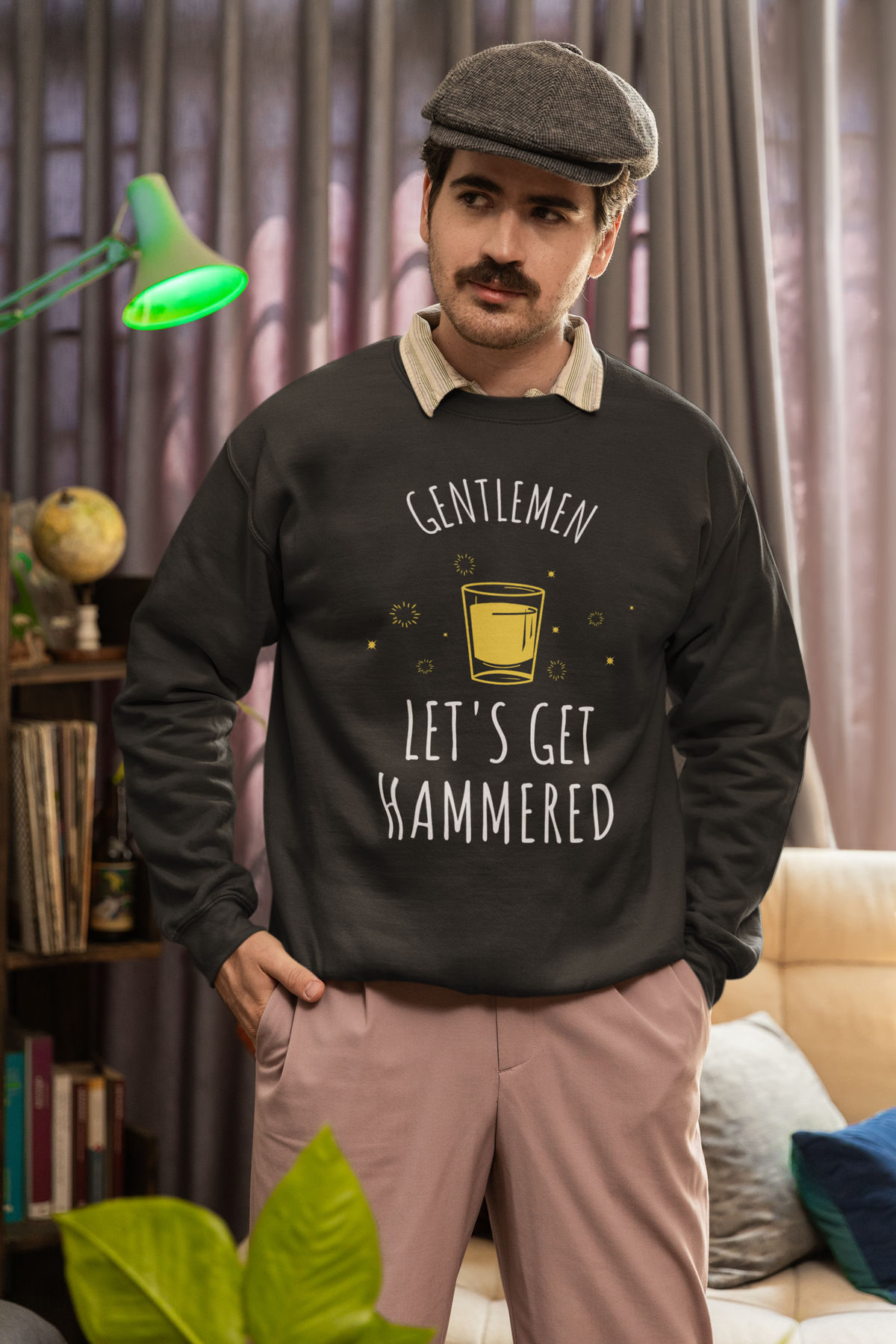 'Gentlemen Let's Get Hammered' sweatshirt in black, bearded man wearing it indoors, bachelor party gift