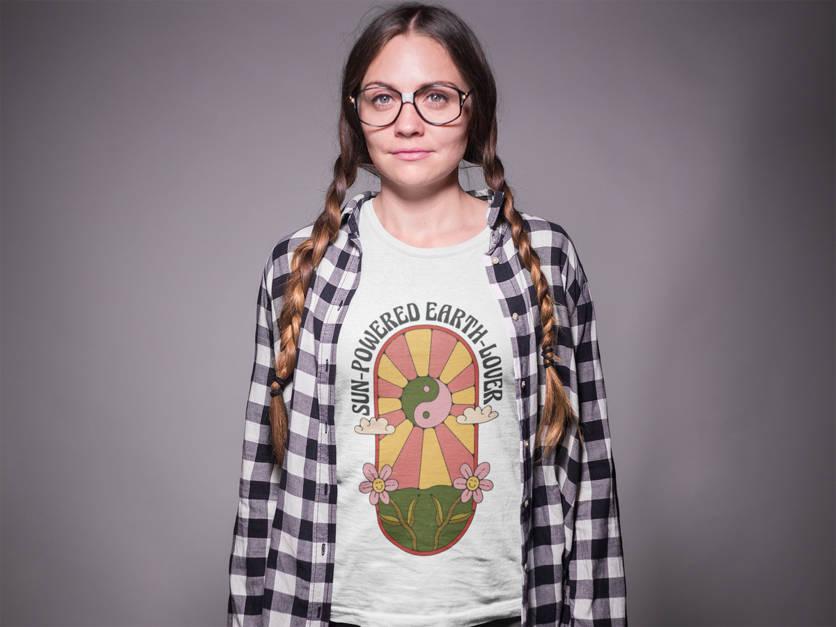 'Sun Powered Earth Lover' t-shirt in white, woman model with braids wearing it under a plaid shirt
