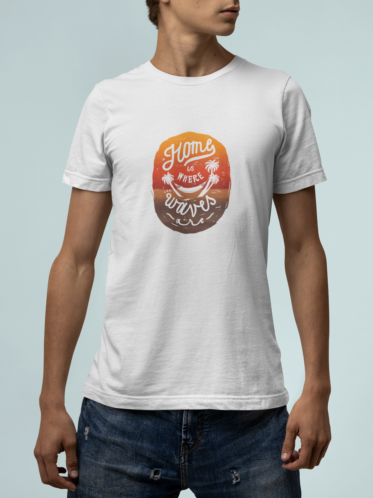 'Home Is Where Waves Are' t-shirt in white, man wearing it with jeans, T-Shirt mockup, Geekpsters