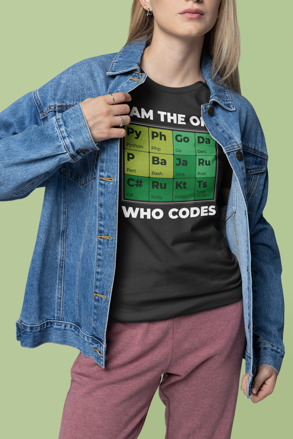 "I Am The One Who Codes" periodic table tee in black, woman wearing it under a denim jacket, geek gift for her