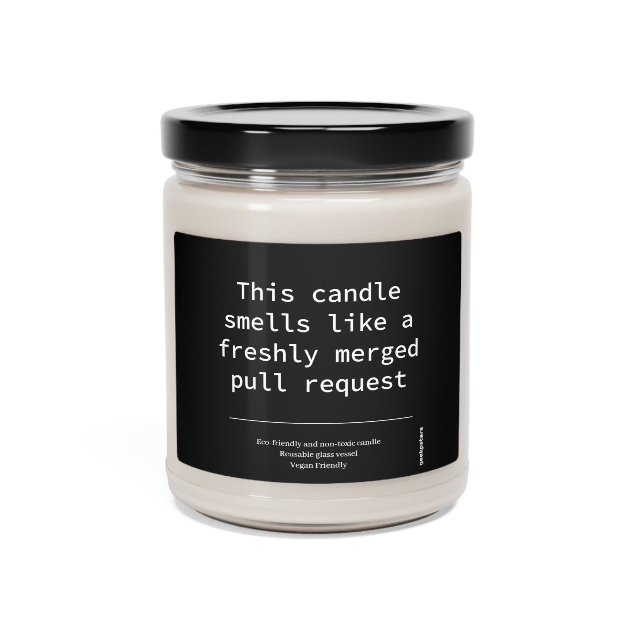 A scented candle with a cotton wick and a humorous label that reads "This Candle Smells Like a Freshly Merged Pull Request - Scented Soy Candle, 9oz.