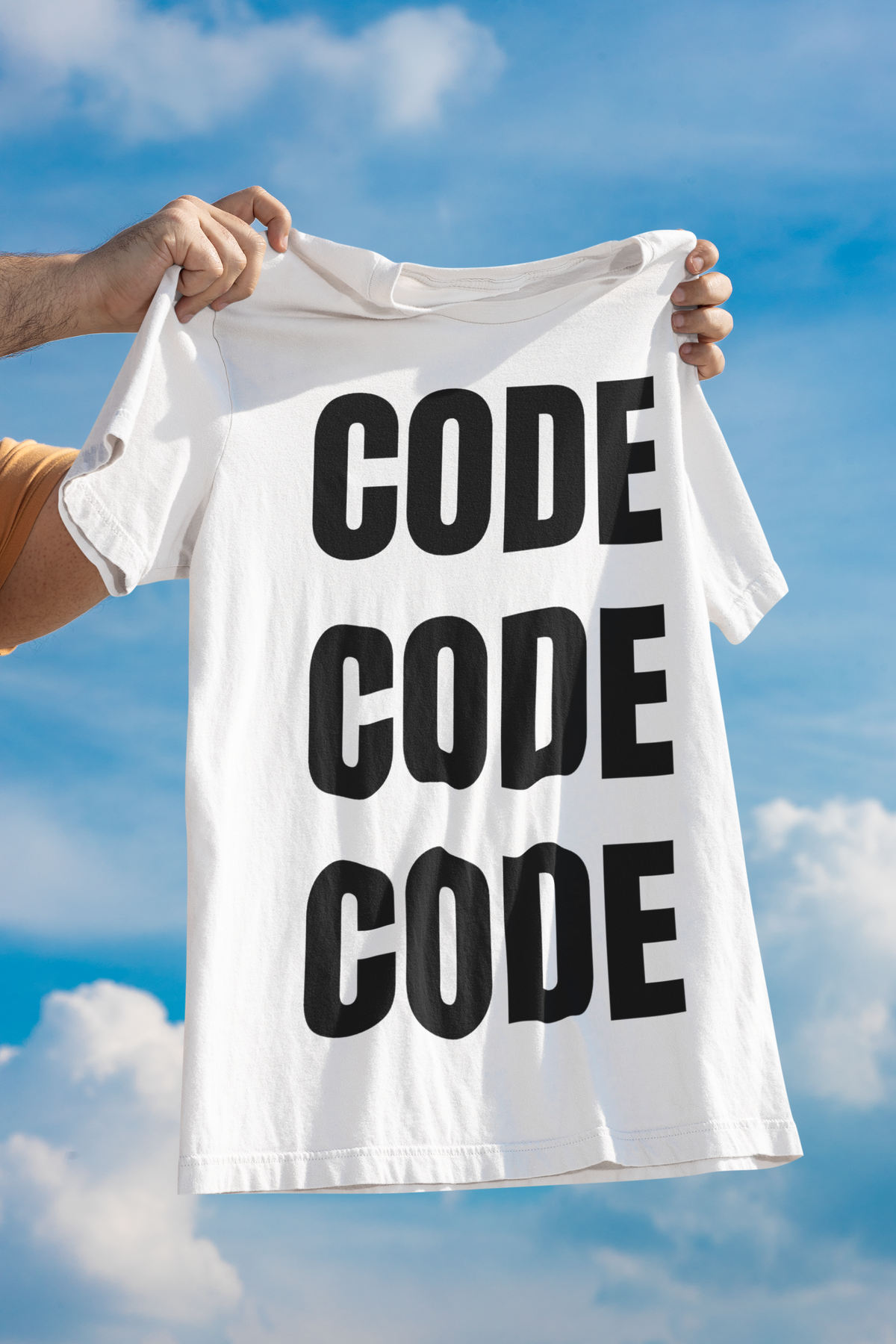 "Code Code Code" women's tee in white, held up against a cloudy sky, funny developer humor t-shirt