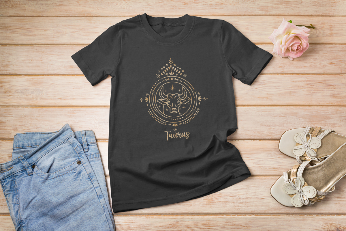 Taurus zodiac T-shirt in black, flat lay on a wood floor, funny gift for zodiac lovers