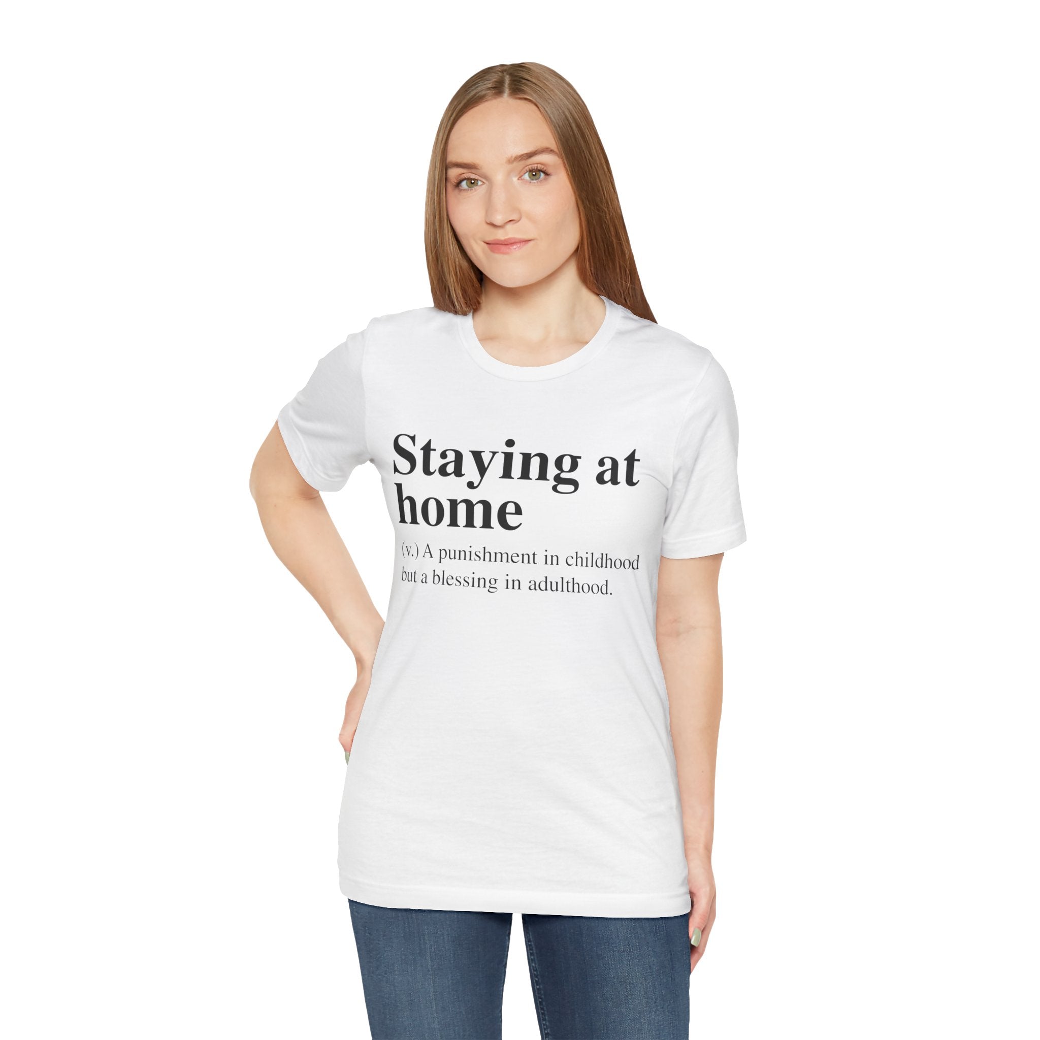 Woman in a comfortable fit Staying at Home T-shirt with the text "staying at home - a punishment in childhood but a blessing in adulthood.