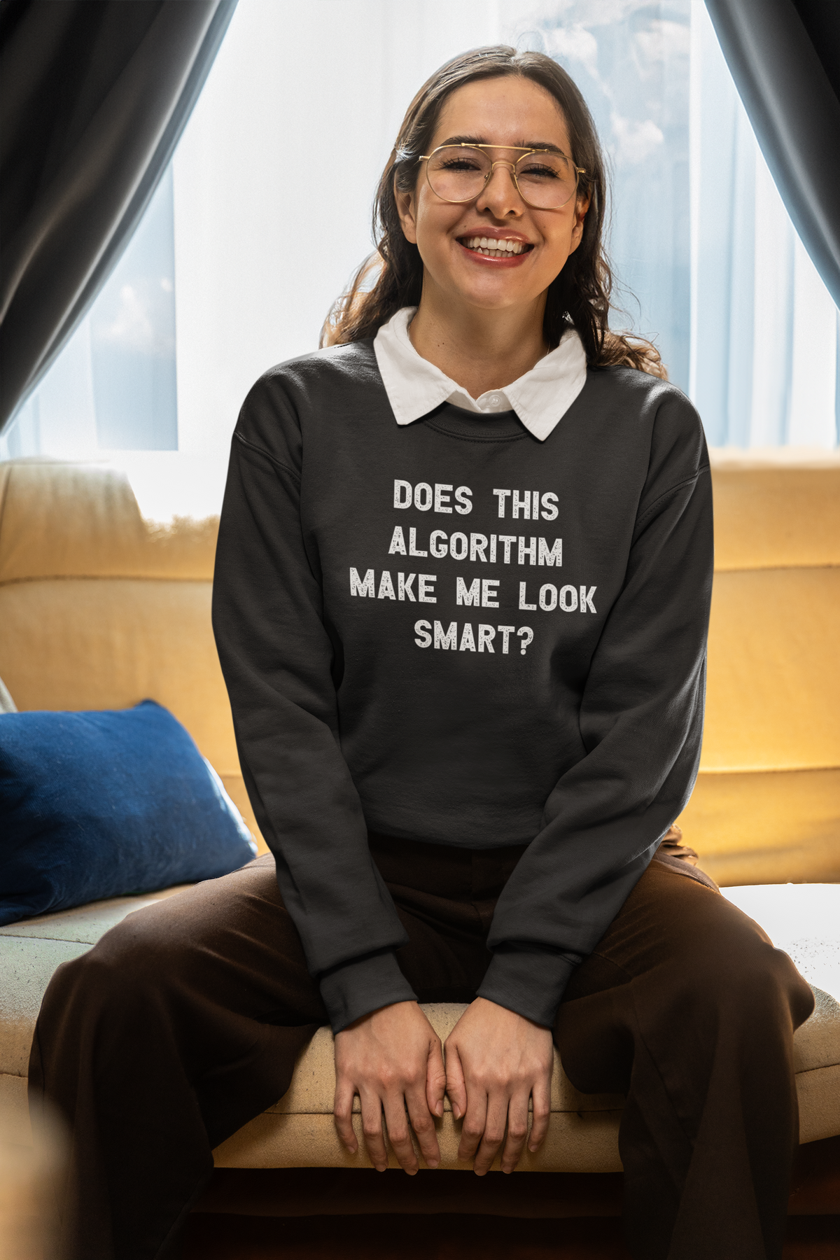 'Does This Algorithm Make Me Look Smart?' sweatshirt in black, woman wearing it on couch smiling, funny coder gift