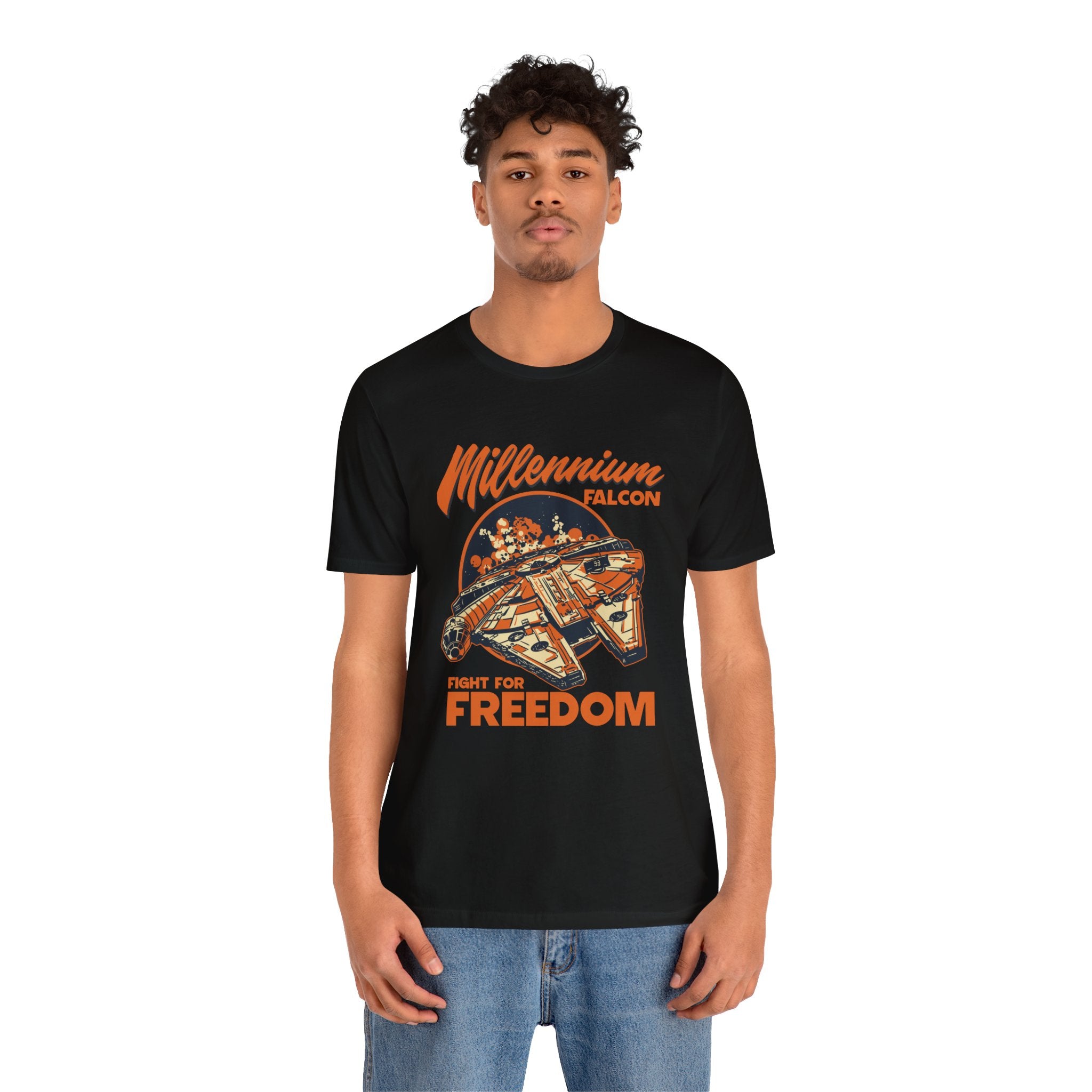 A young man wearing a black t-shirt with a "Falcon" quality print and text that reads "fight for freedom," paired with blue jeans.