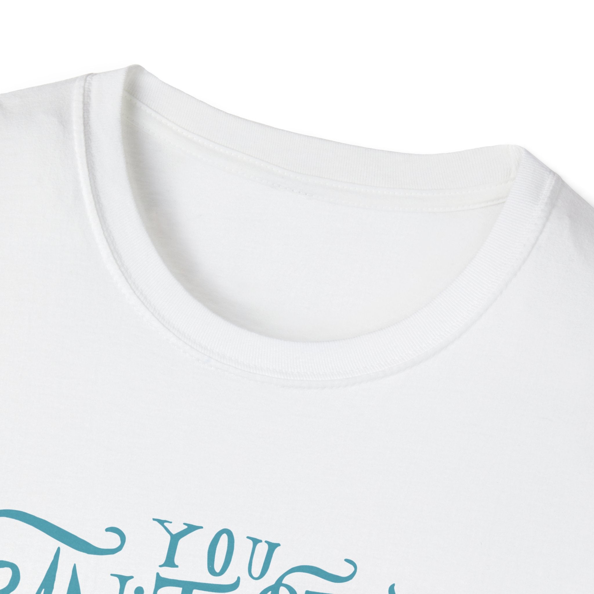 Close-up of the "Can't Stop Surfing T-Shirt," a white garment with blue cursive text partially visible, displaying the word "YOU." This vintage-inspired design embodies the essence of a classic surfing shirt, ideal for surfing enthusiasts.