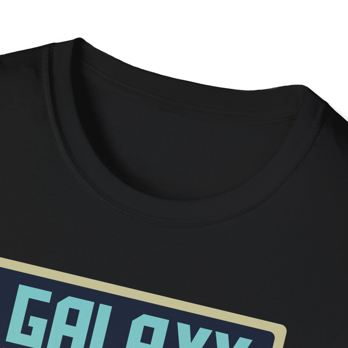 Close-up of "Galaxy Invaders" teal text print on black t-shirt collar, retro arcade graphic detail