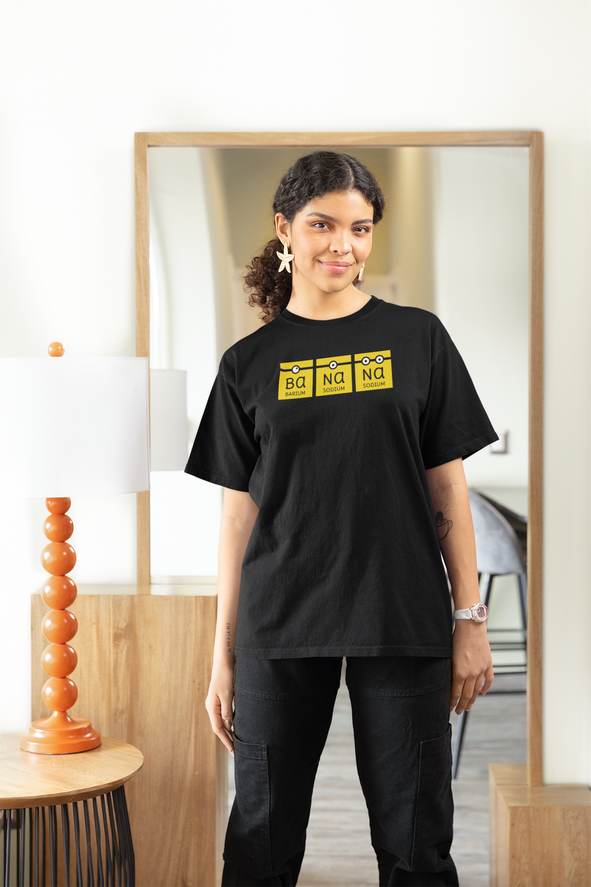 'Ba-Na-Na' women's fitted t-shirt in black, woman wearing it oversized at home, cozy banana pun gift