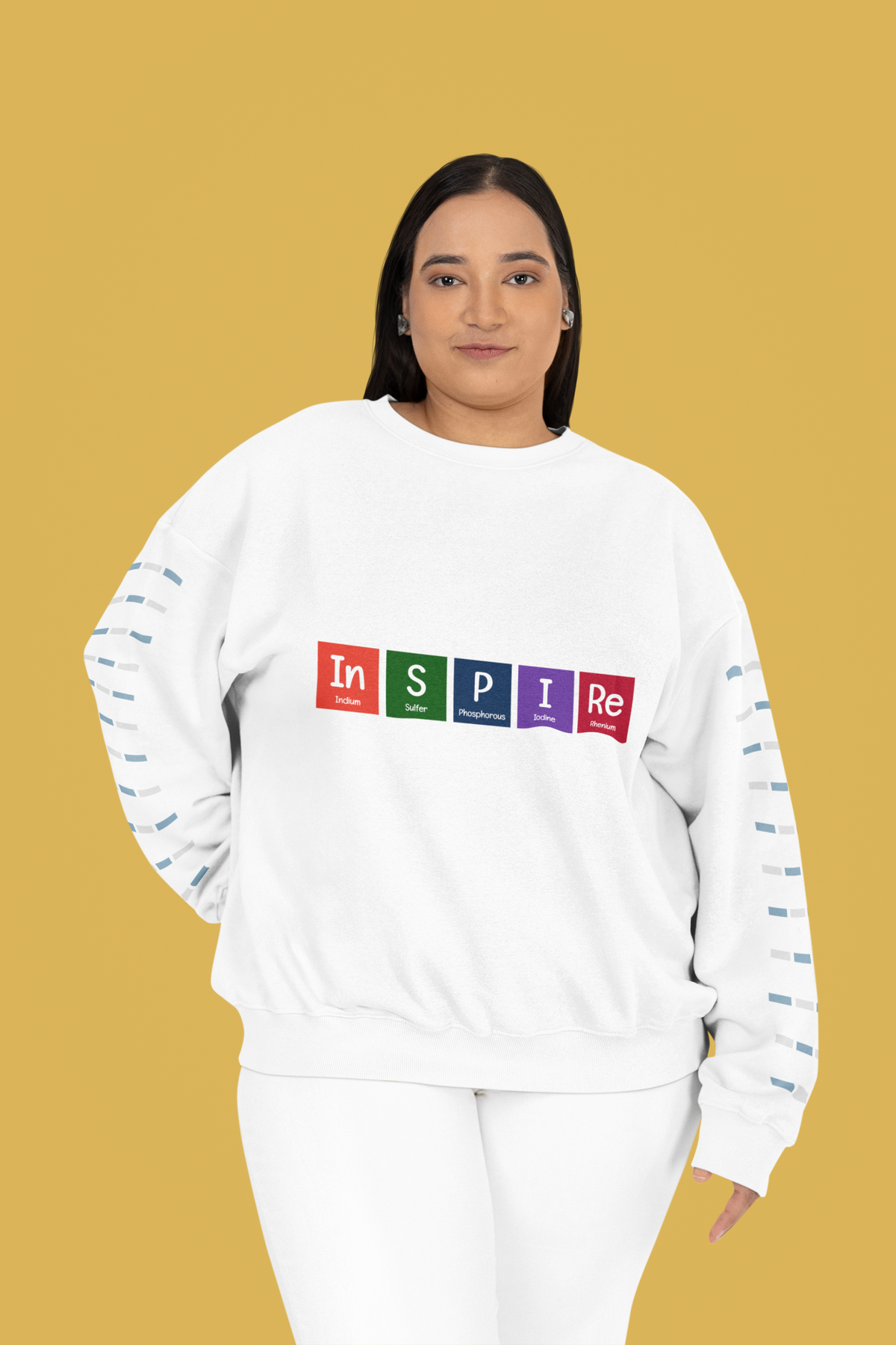 'InSPIRe' periodic table sweatshirt in white, plus size woman wearing it, mustard backdrop, science gift