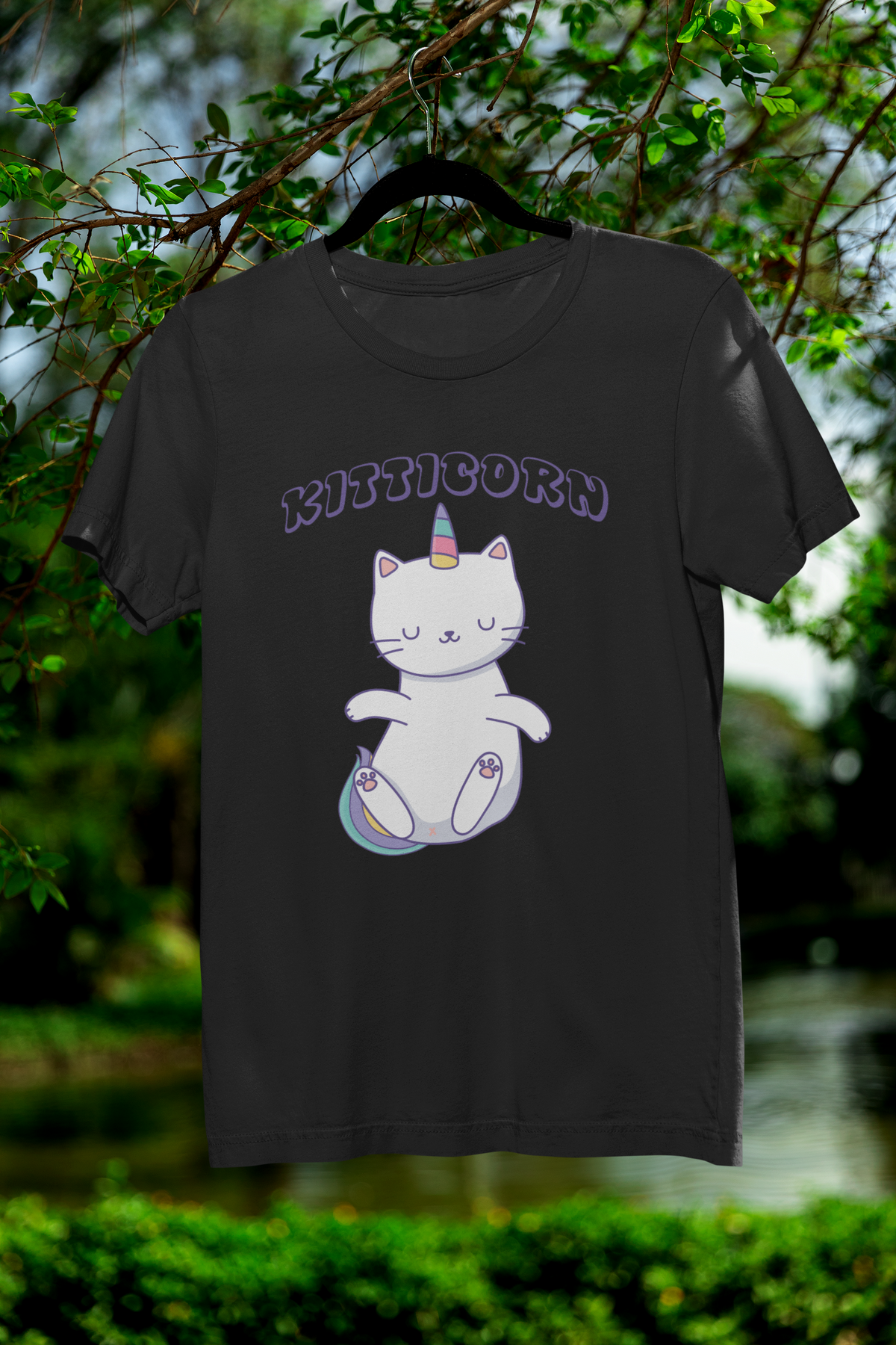 "Kitticorn" unicorn cat graphic t-shirt in black, hanging outdoors on tree branch, cute cat lover gift