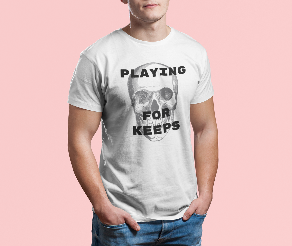 'Playing For Keeps' skull t-shirt in white, man wearing it on pink background, edgy gothic gift shirt
