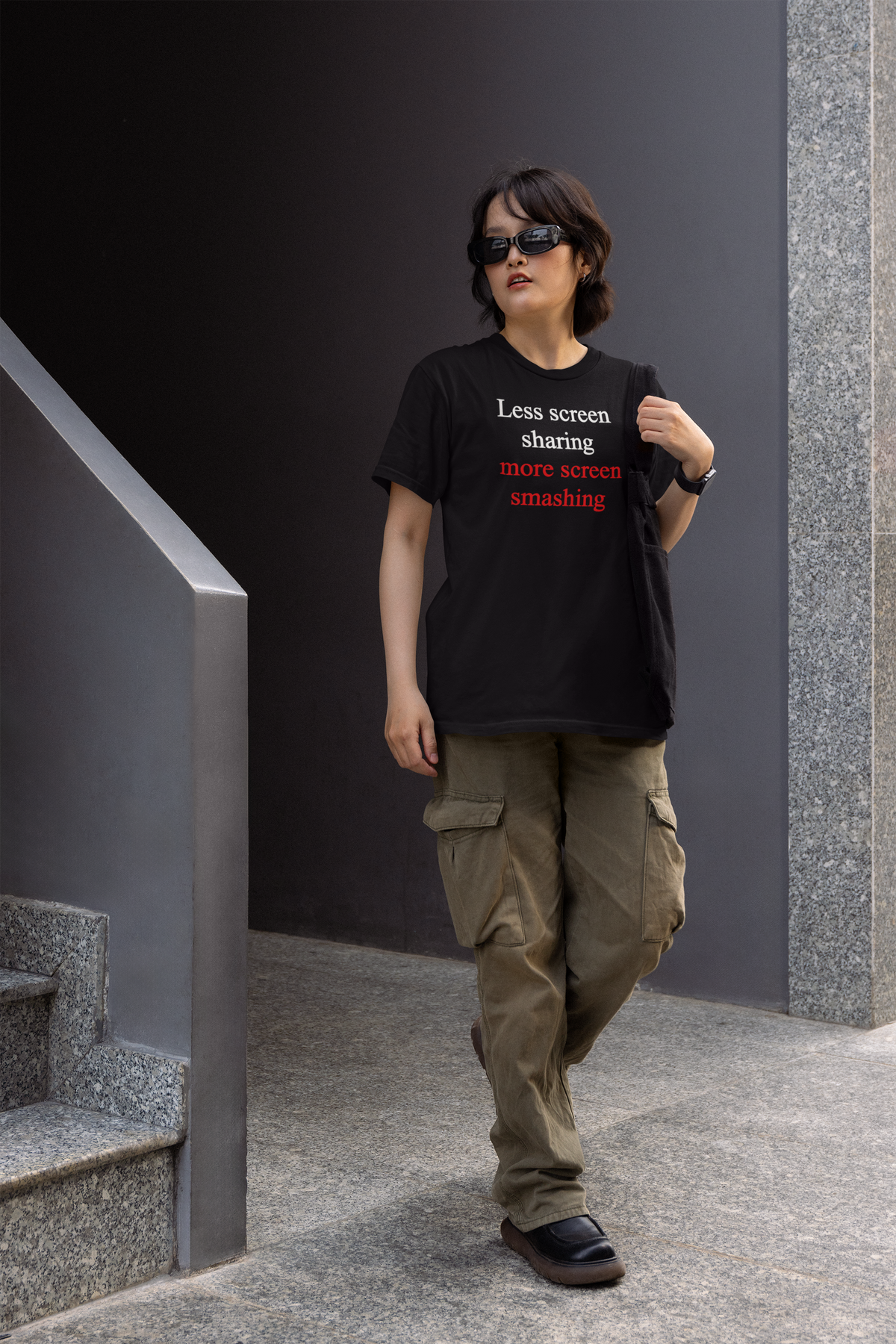 'Less screen sharing more screen smashing' womens tee in black, man walking outdoors wearing it, funny gamer tee