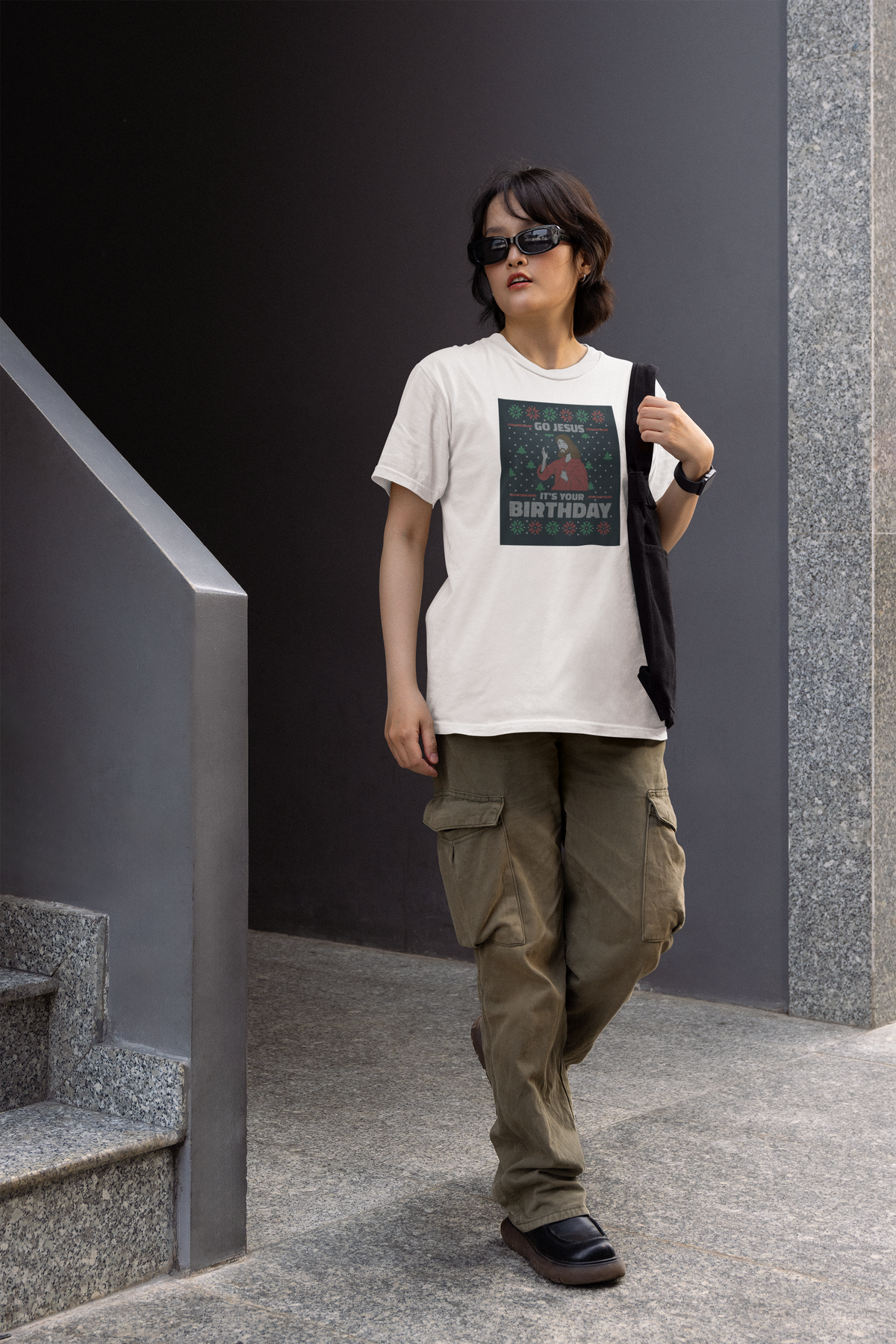 'Go Jesus It's Your Birthday' Women's T-Shirt in white, woman walking outdoors wearing it, funny gift