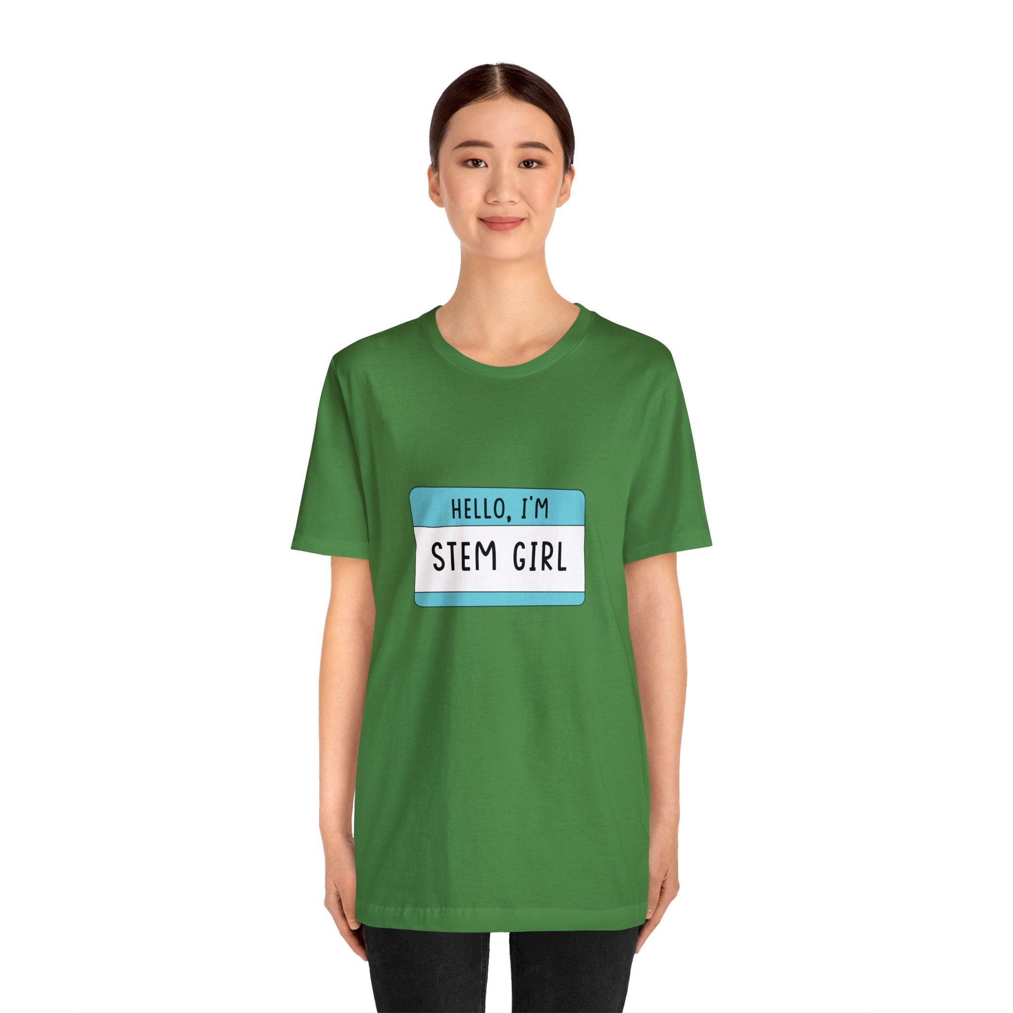 Young woman in a green Hello, I'm Stem Girl T-Shirt, standing against a white background.