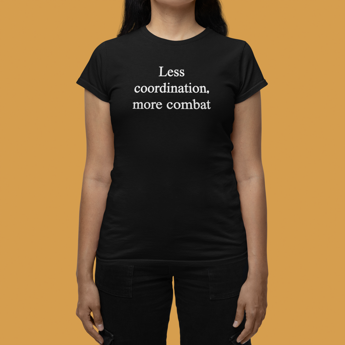 'Less Coordination More Combat' women's tee in black, woman on orange background, funny sarcastic gift