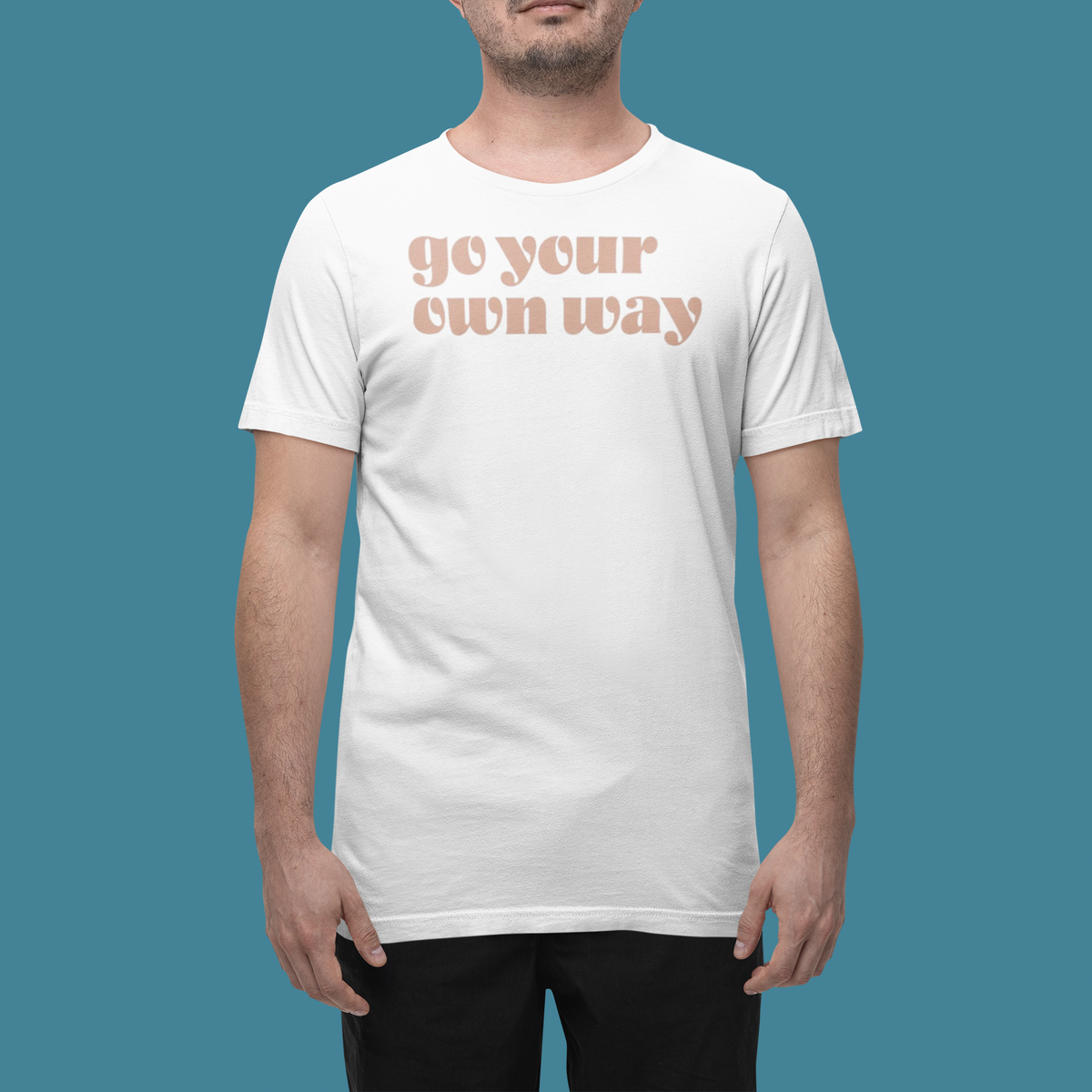 'Go Your Own Way' t-shirt in white, man wearing it in a studio, T-Shirt mockup, Geekpsters