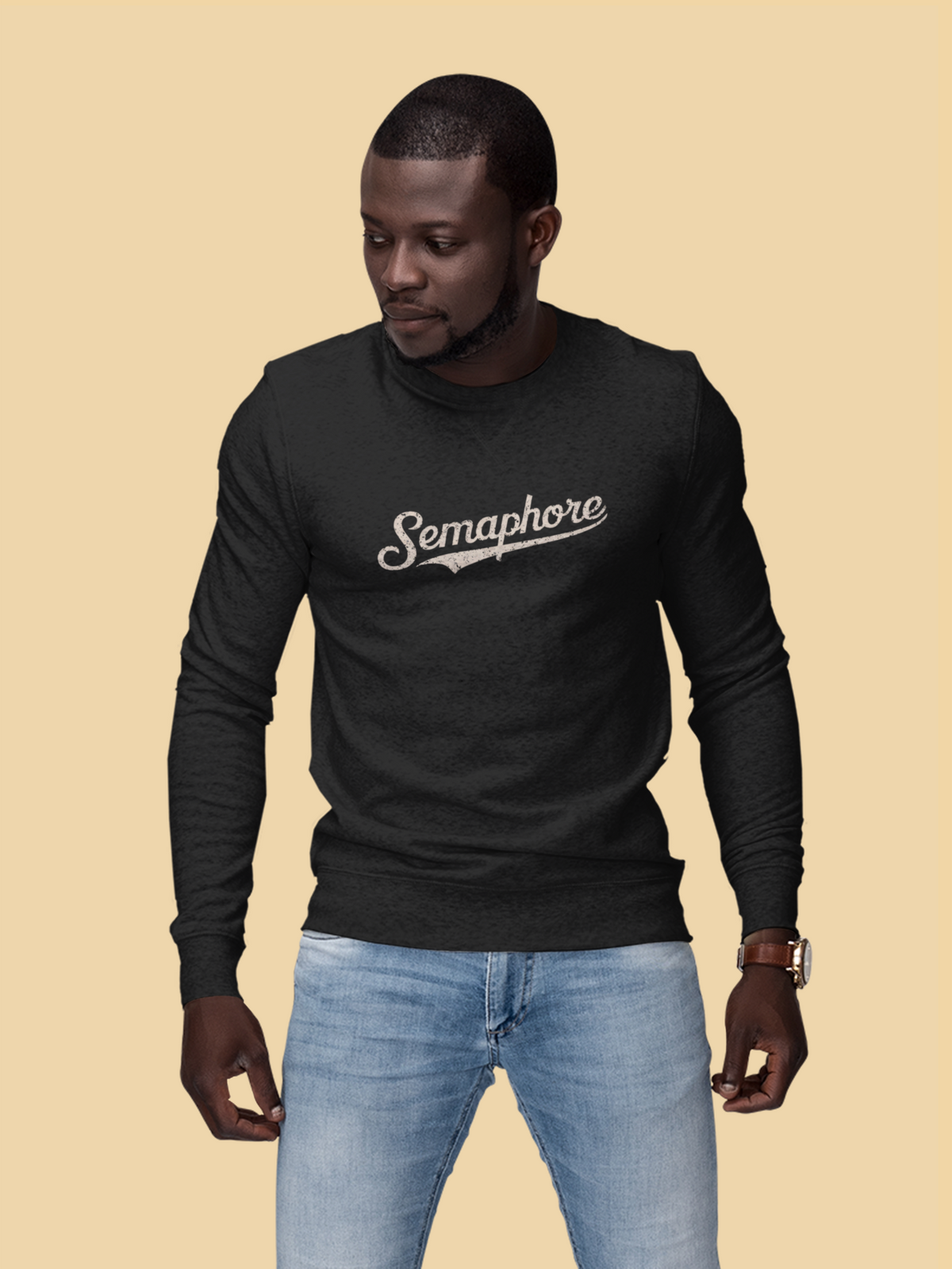 Semaphore script logo sweatshirt in black, man wearing it on a tan background, trendy graphic gift