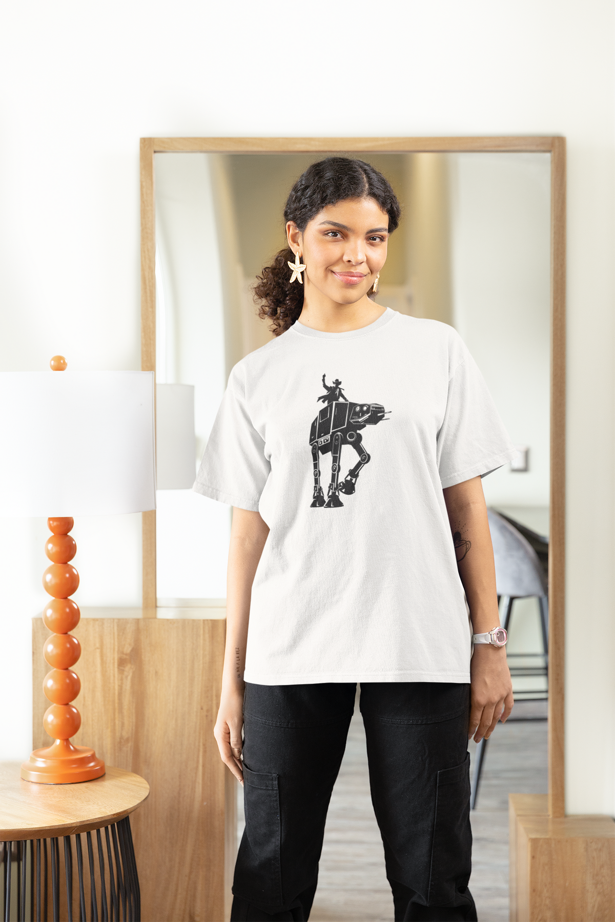'Riding AT-AT' womens tee in white, woman wearing it in living room, funny sci fi pun gift