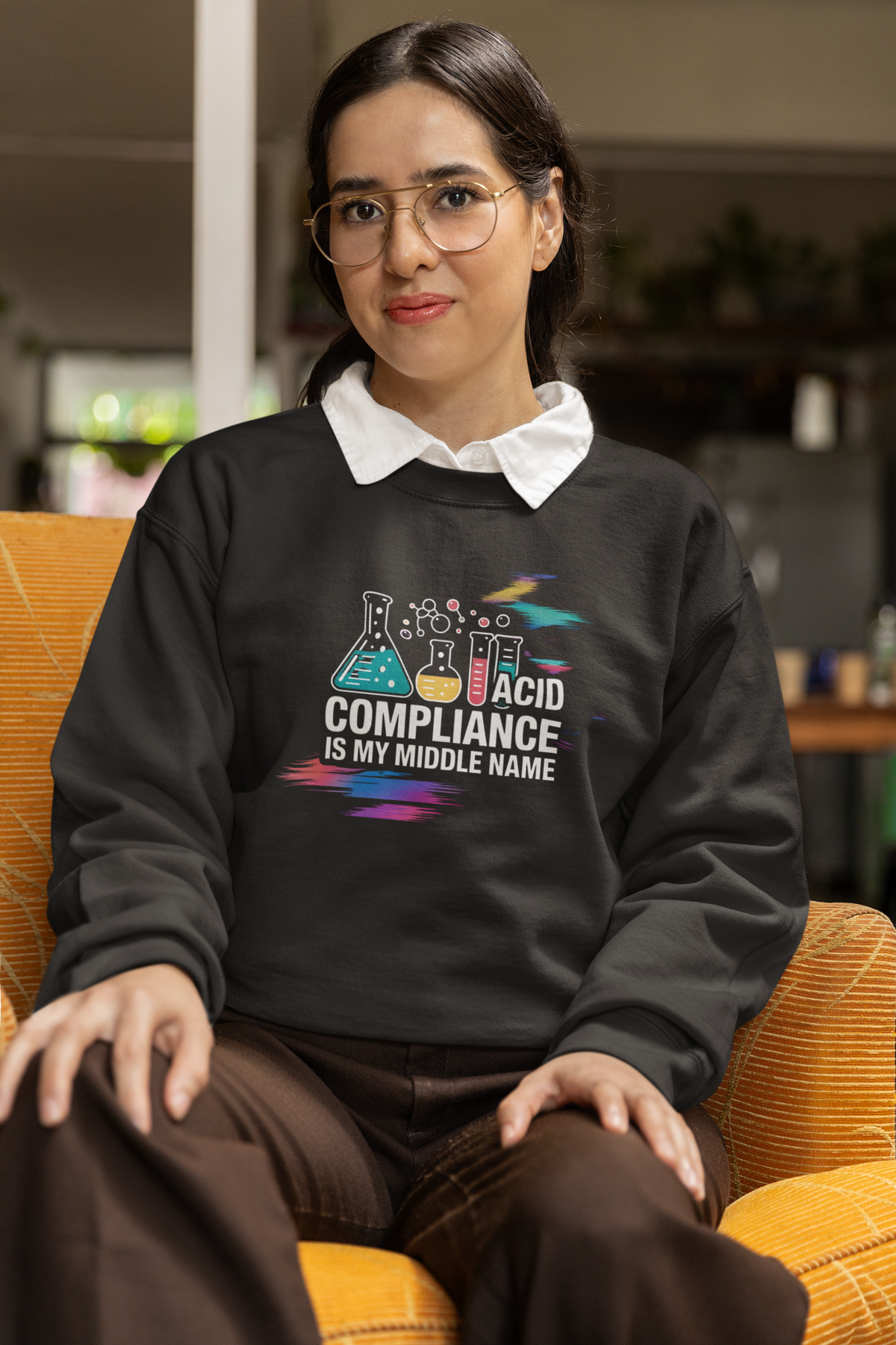 'ACID Compliance Is My Middle Name' sweatshirt in black, woman wearing it seated indoors, funny DBA gift idea