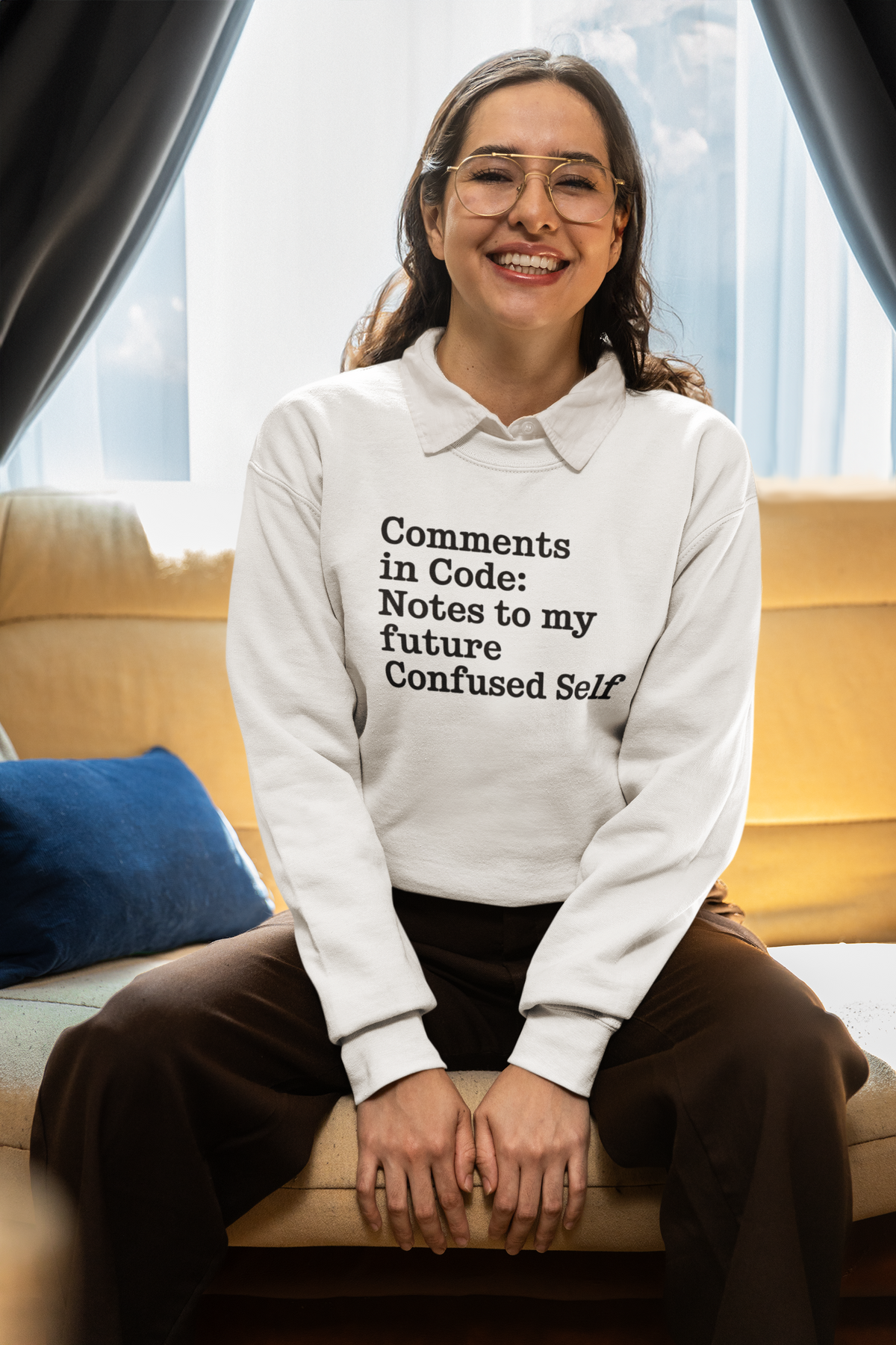 'Comments in Code' sweatshirt in white, woman sitting wearing it indoors, funny programmer sweatshirt